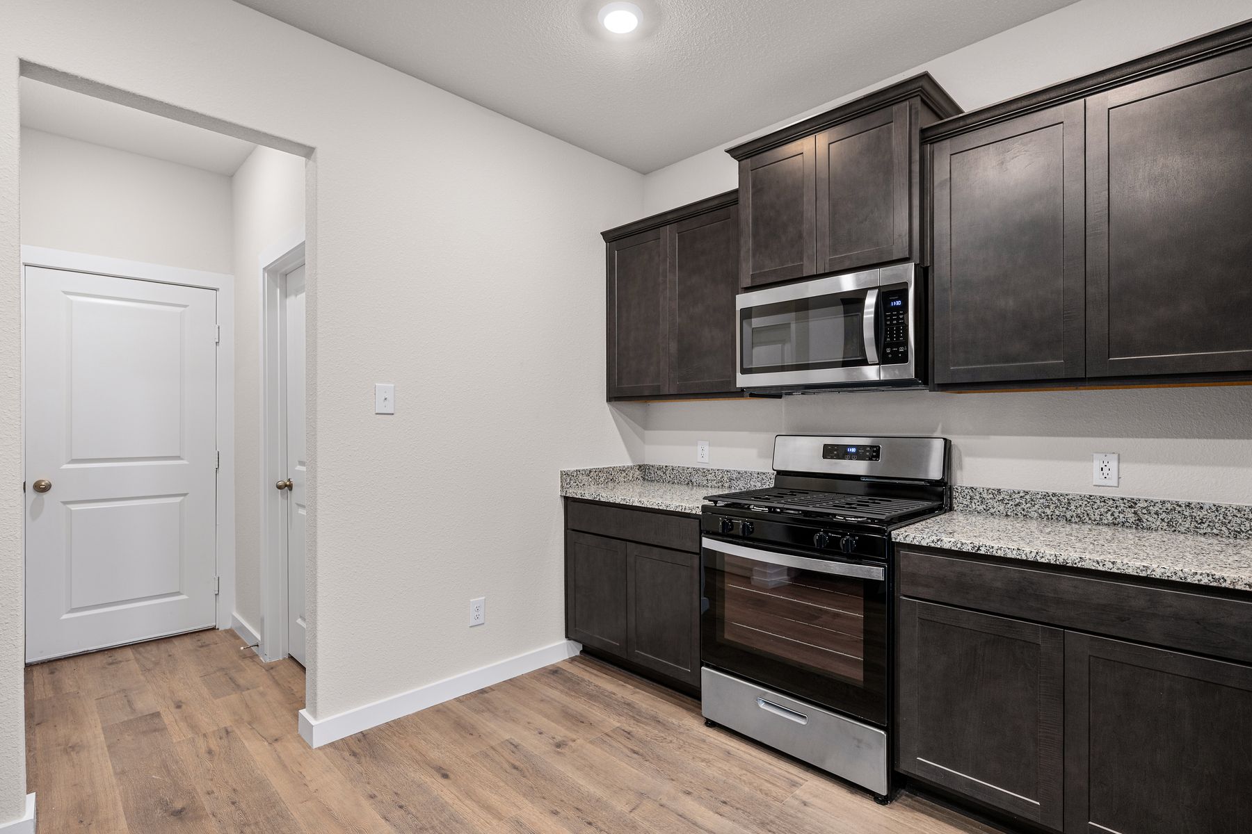 The kitchen has beautiful wood cabinetry.