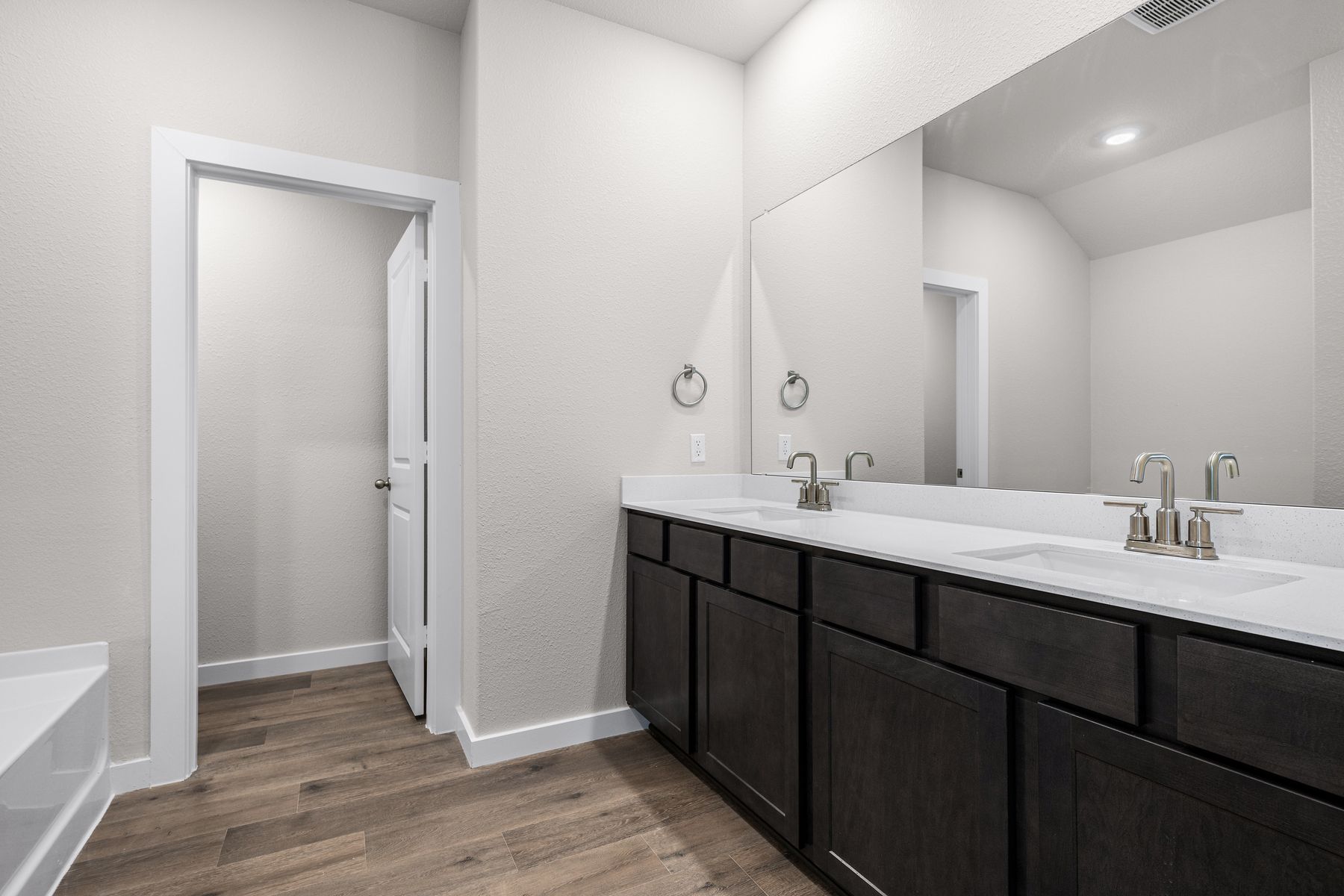The master bathroom has a sprawling dual-sink vanity.