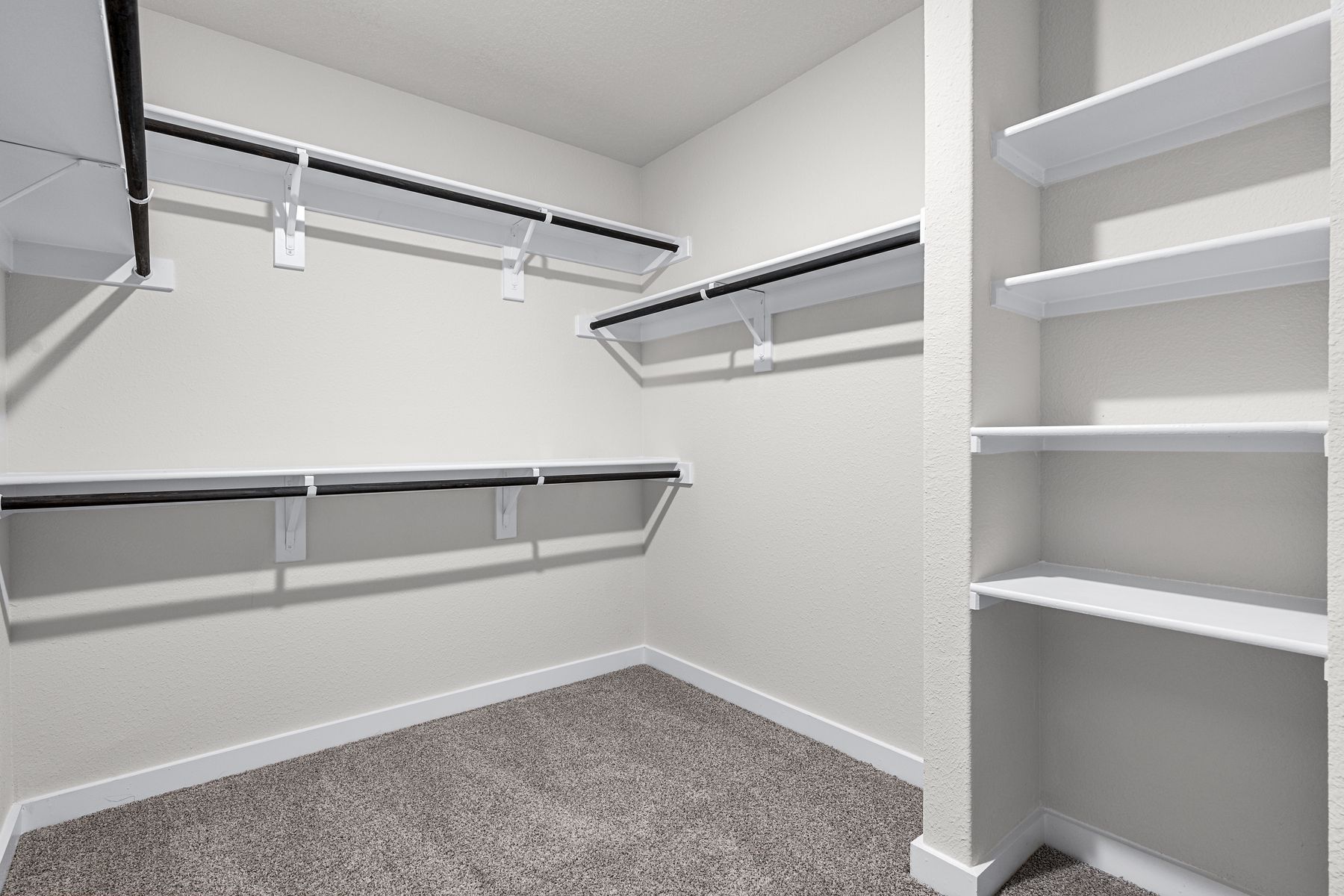 The master walk-in closet has plenty of hanging space and shelves for all of your clothes, shoes and personal items.