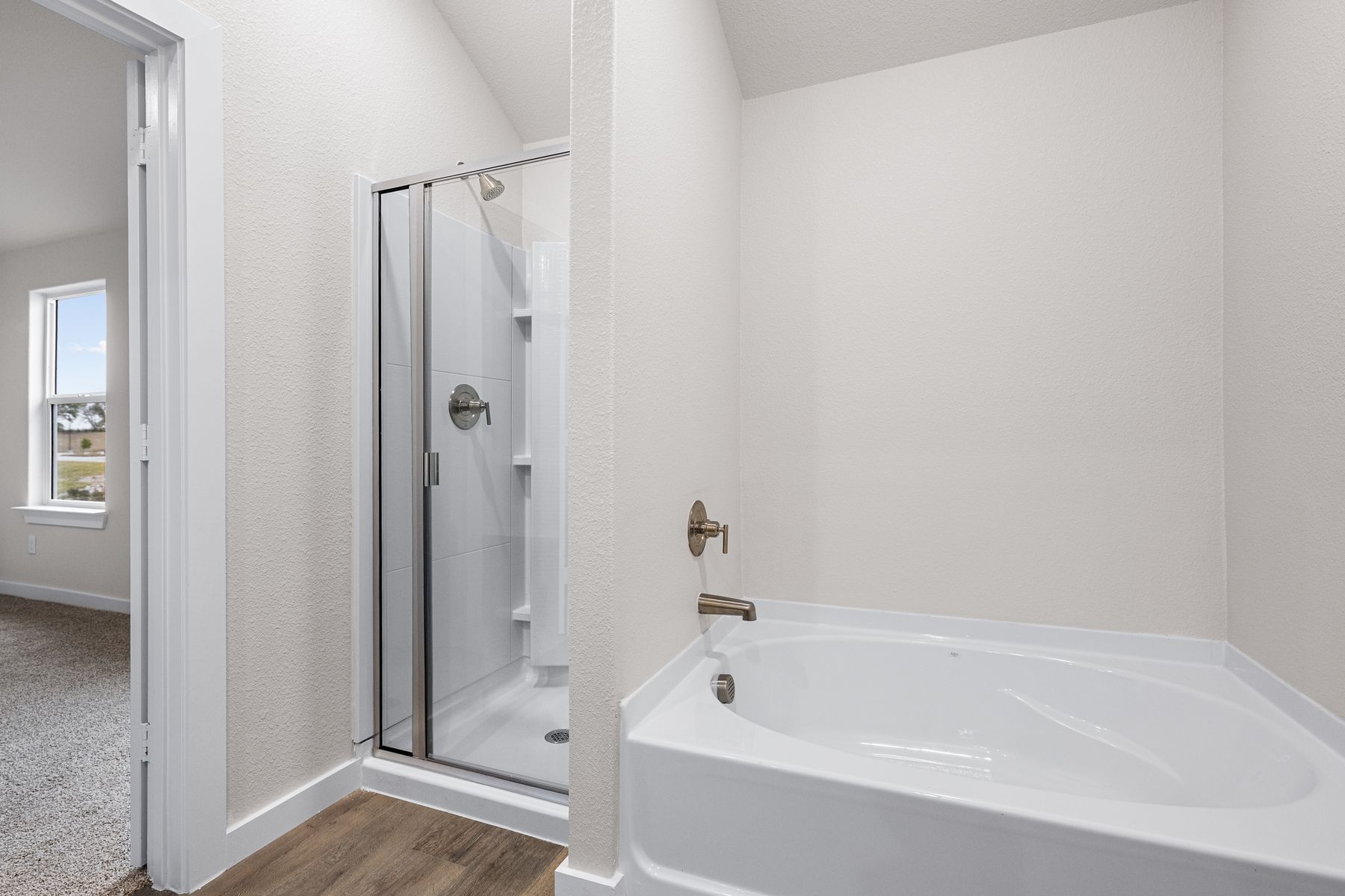 The master bathroom has a class, walk-in shower and garden tub.