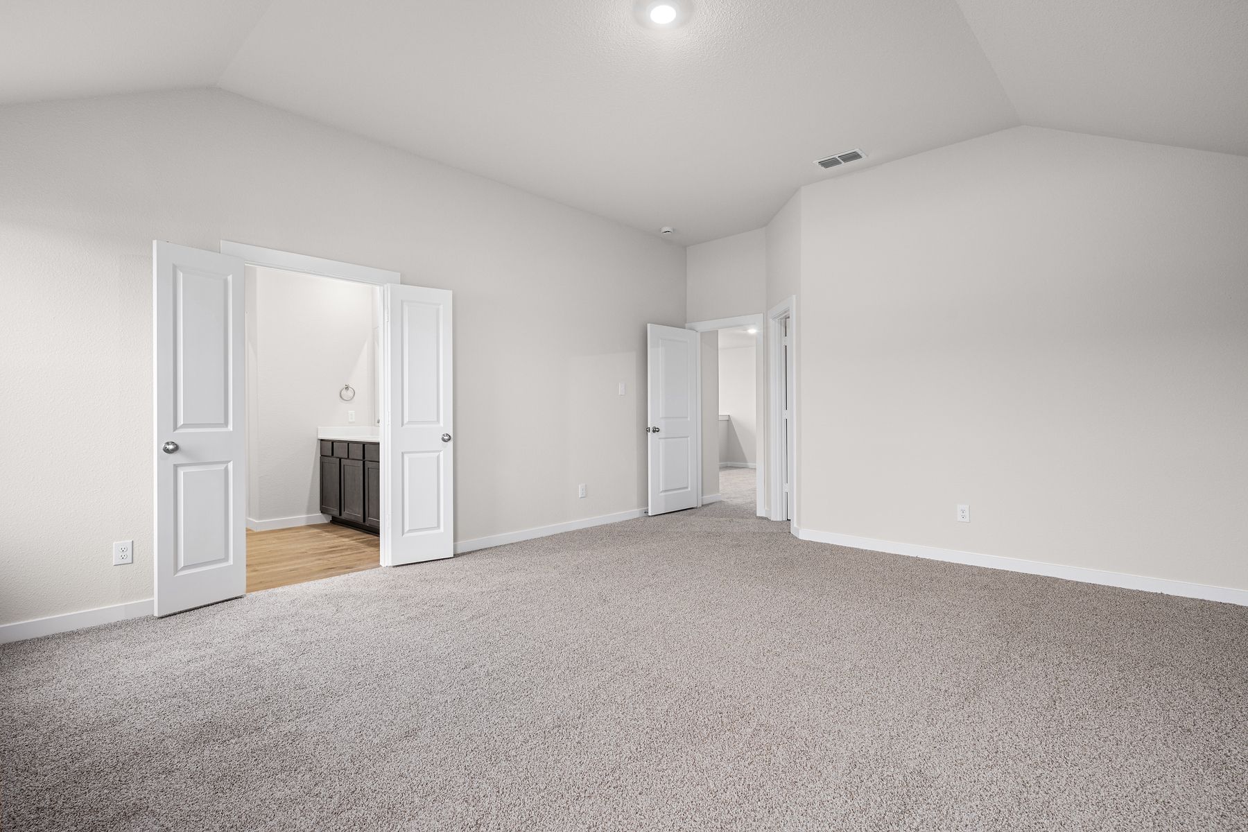 The master suite has a large bedroom, ensuite bathroom and a walk-in closet. 