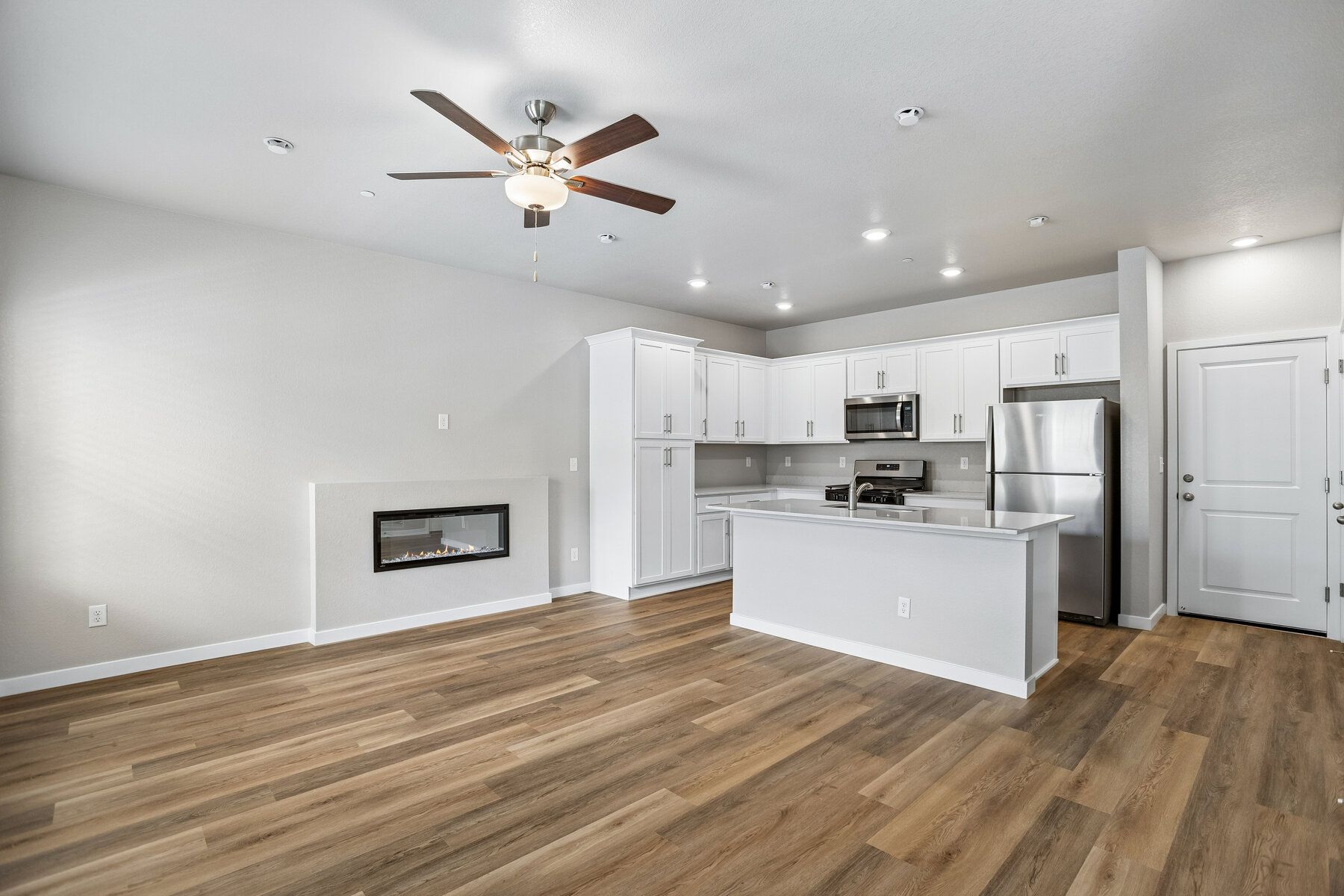 The family room is spacious with an electric fireplace.