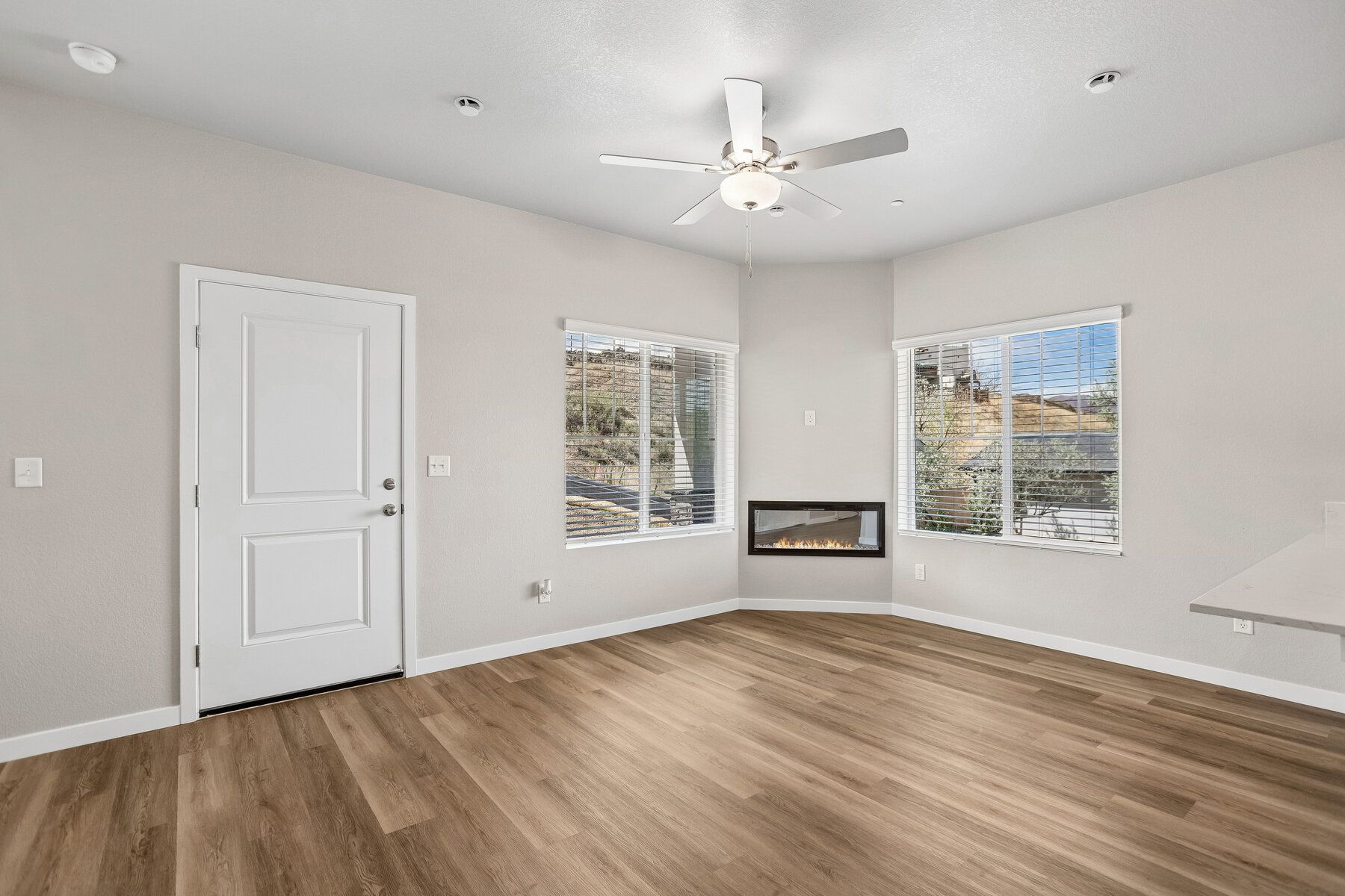 The family room is spacious with a ceiling fan and electric fireplace