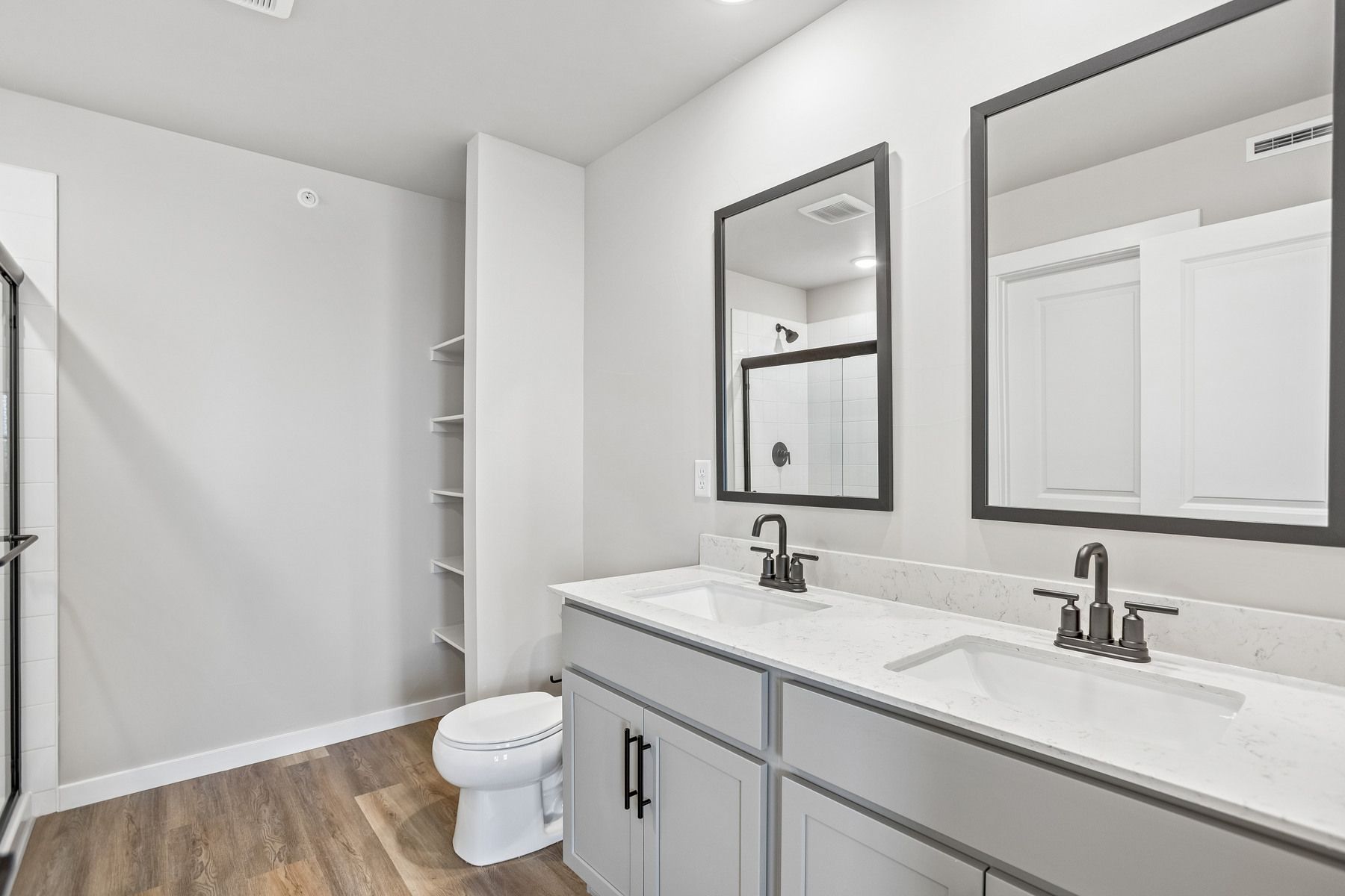The master bathroom has a large vanity with a step in shower.