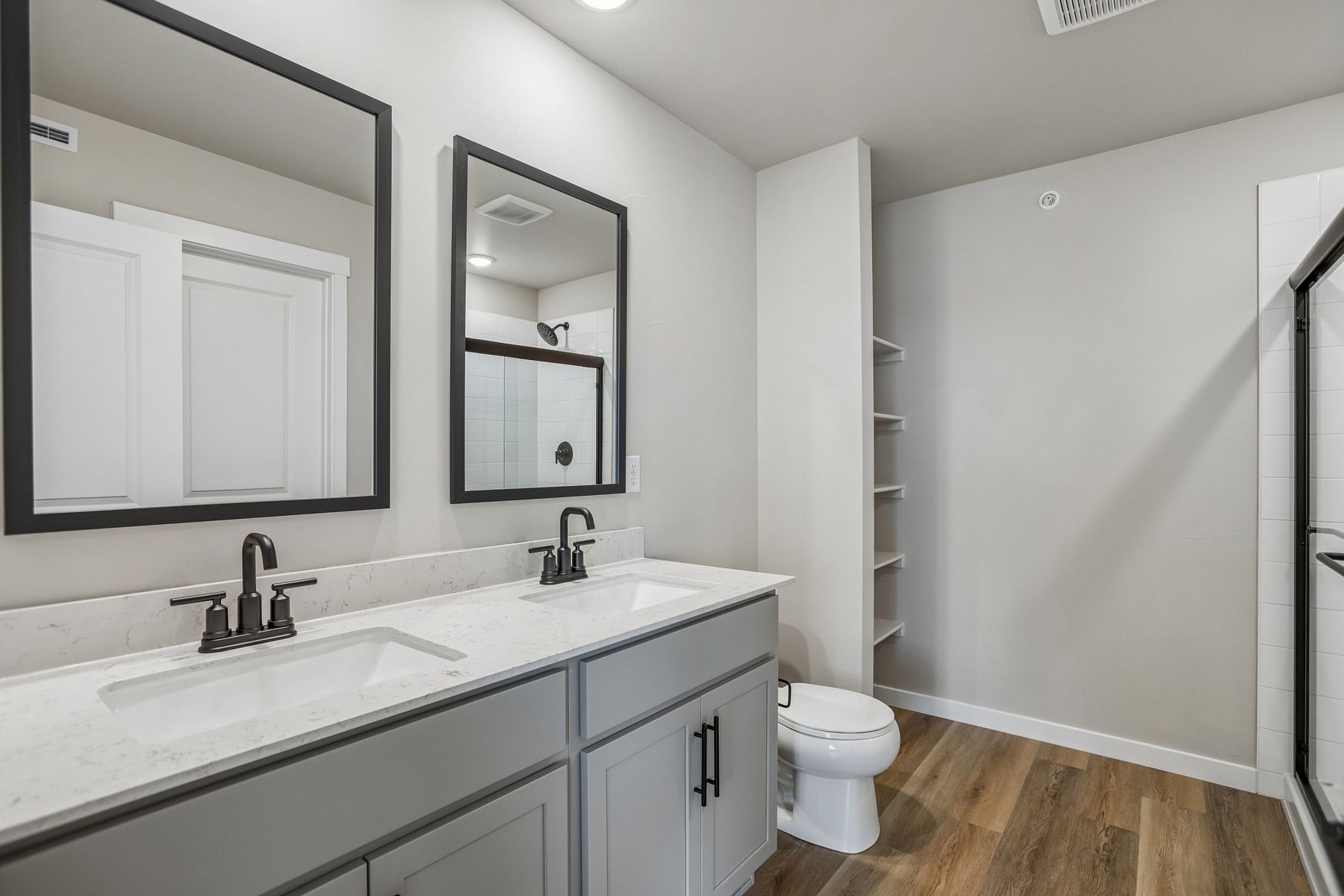The master bathroom has a large vanity with a step in shower.