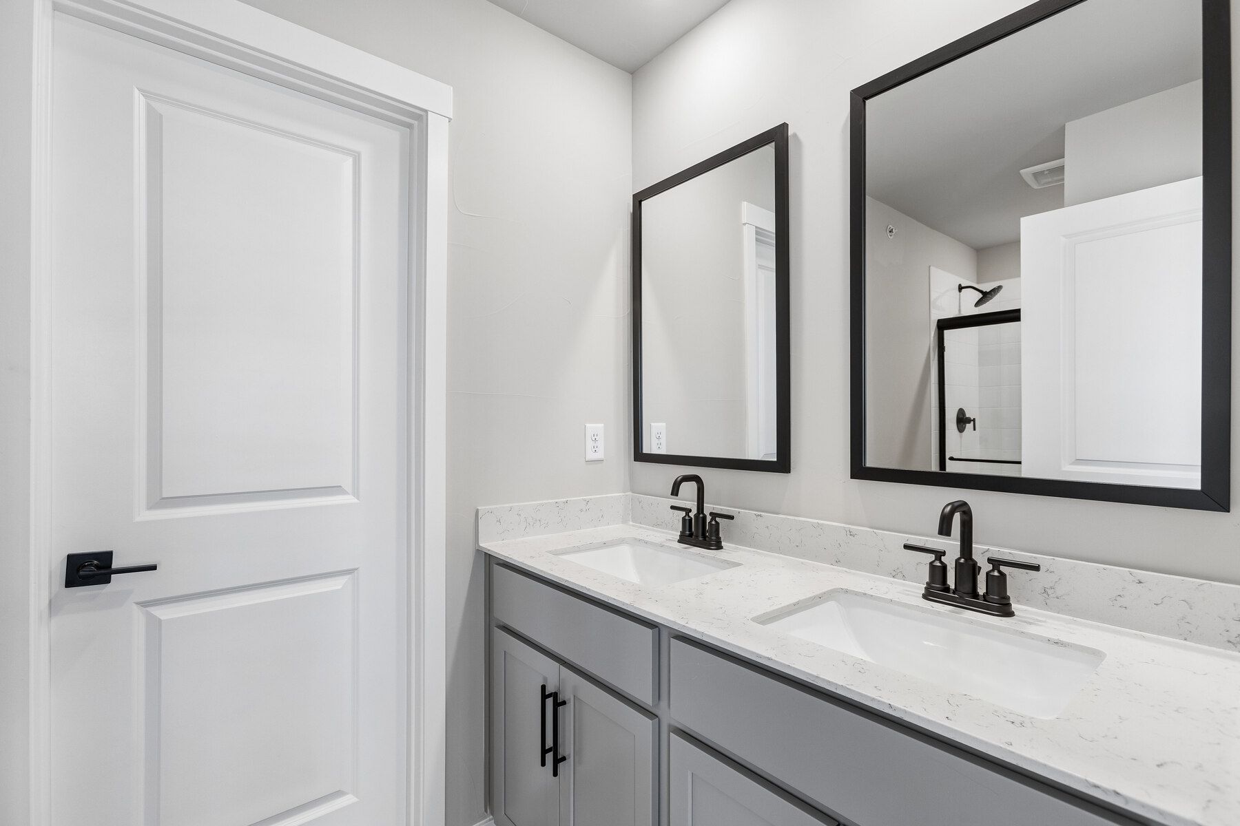 The master bathroom has a large vanity with a step in shower.