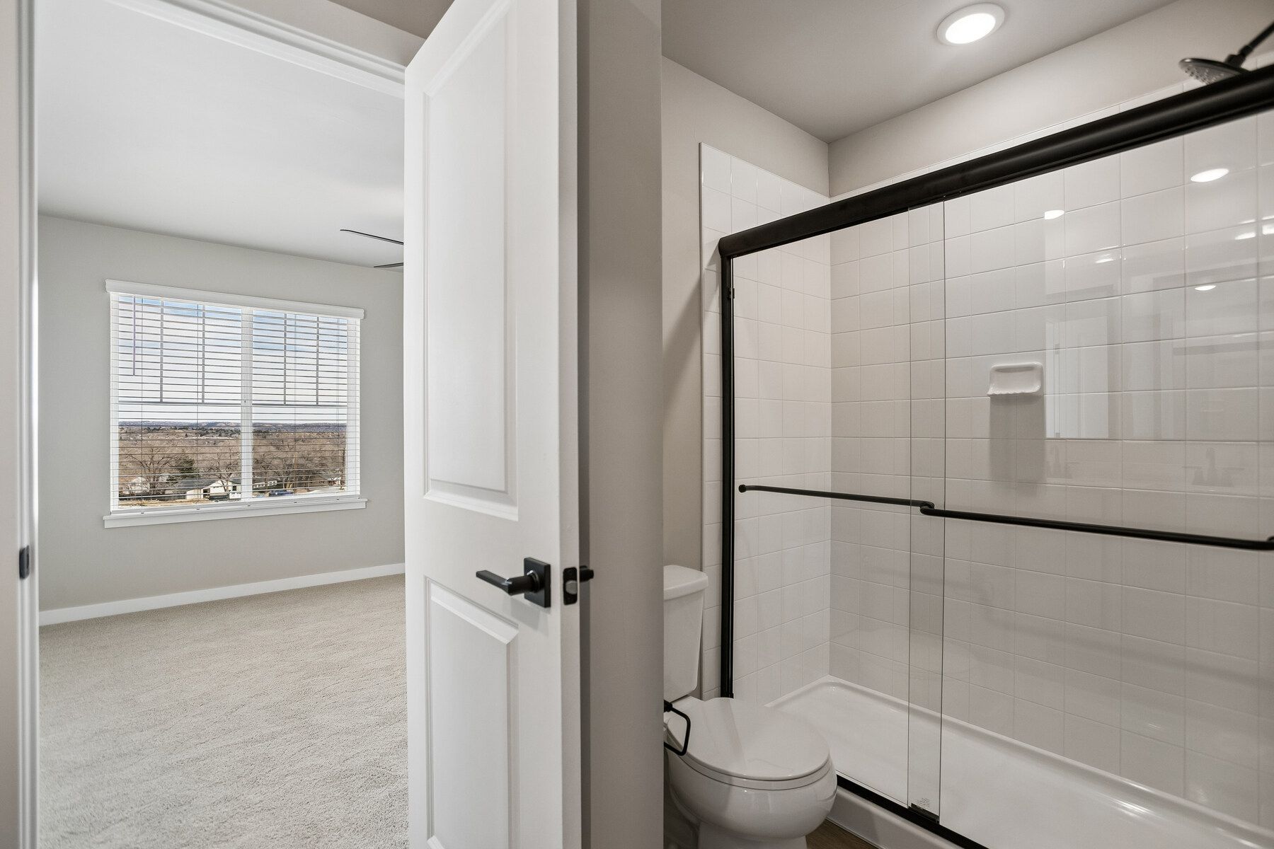 The master bathroom has a large vanity with a step in shower.