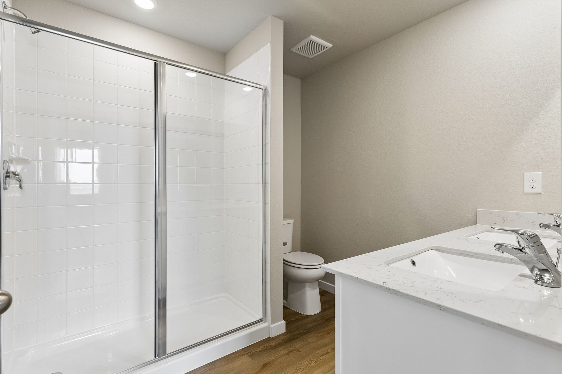 The master bathroom has a large vanity with a step in shower.