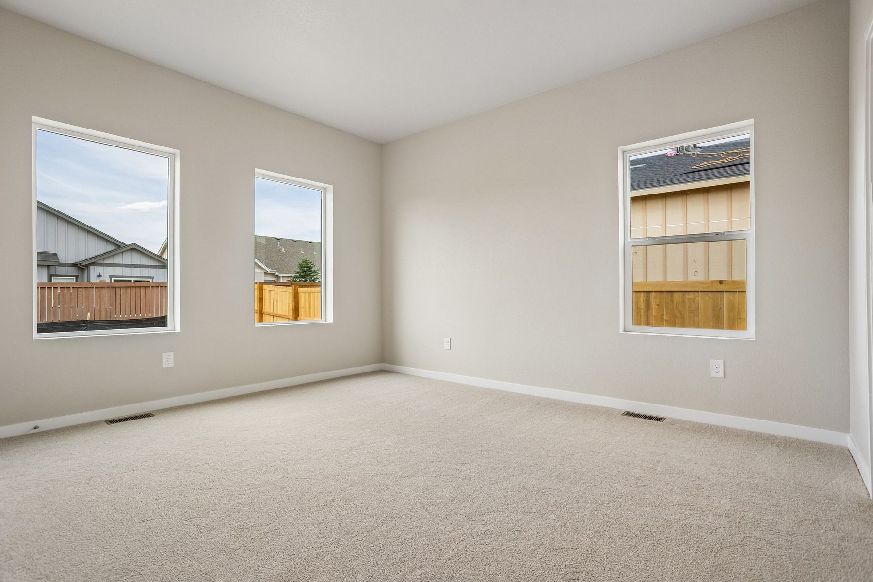 The master bedroom is spacious with large windows.