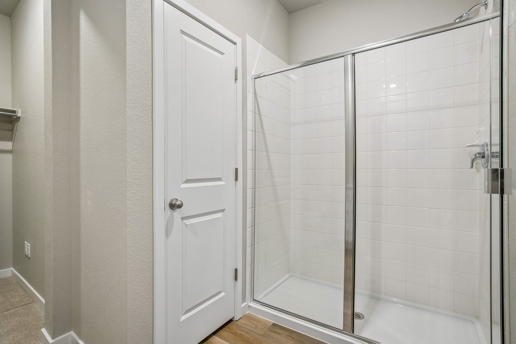 The master bathroom has a large vanity with a step in shower.