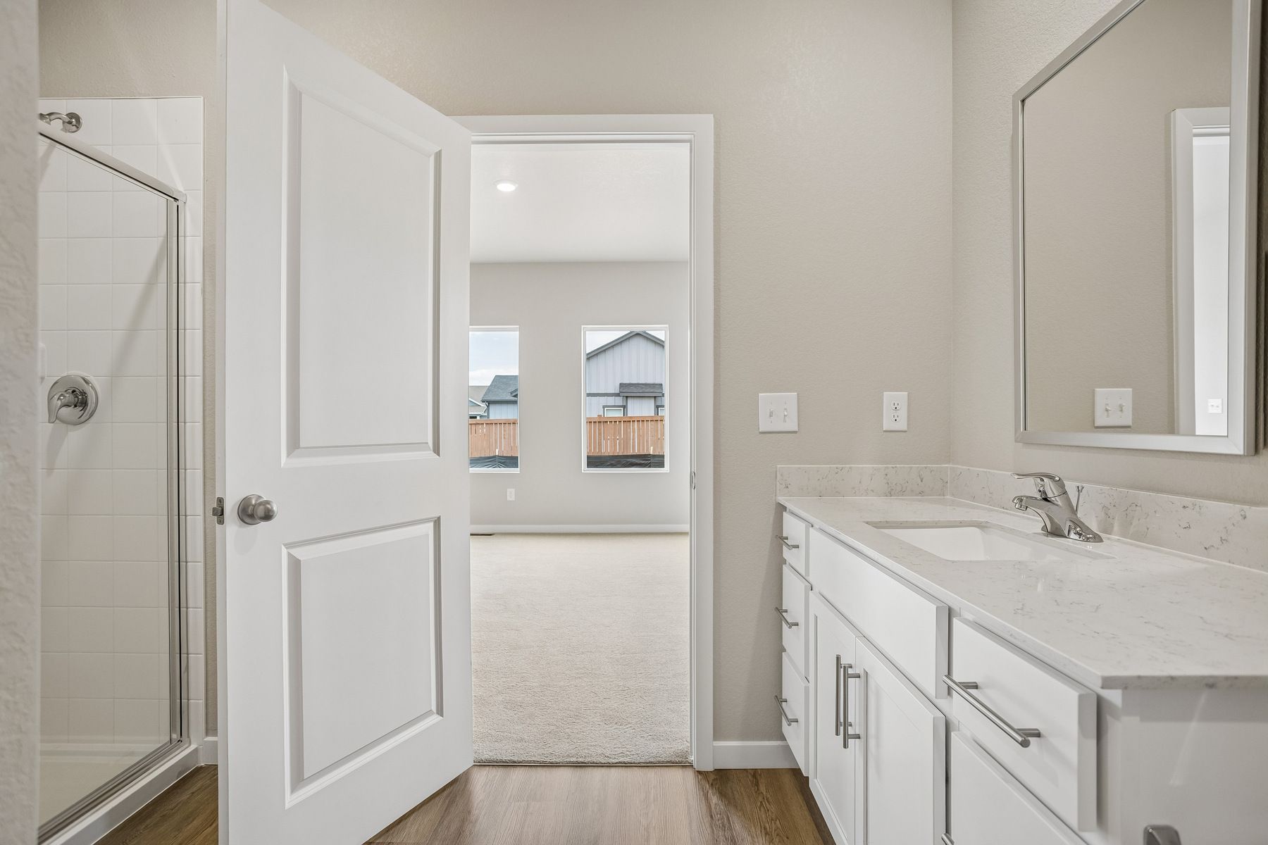 The master bathroom has a large vanity with a step in shower.