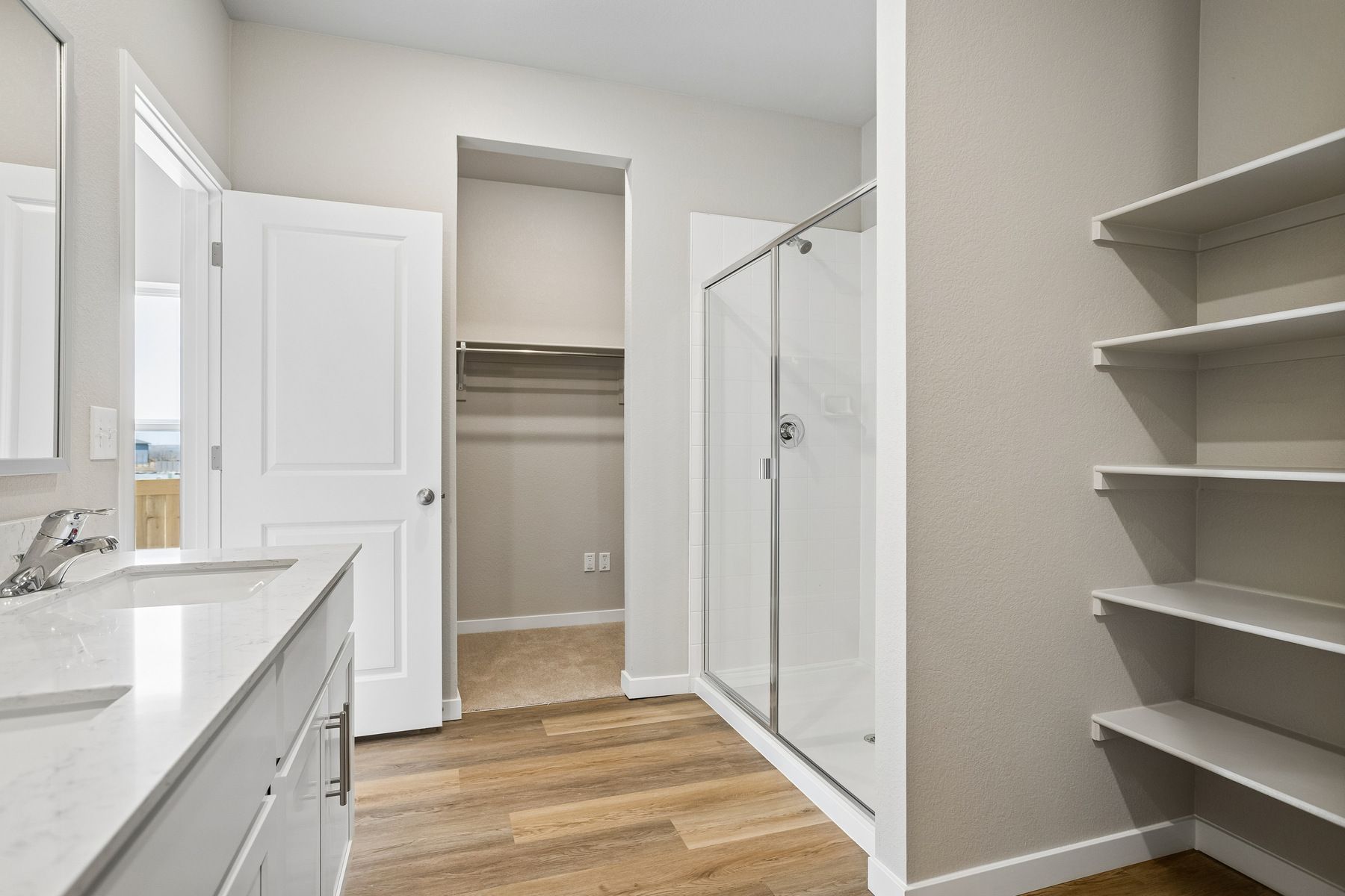 The master bathroom has a large vanity with a step in shower.