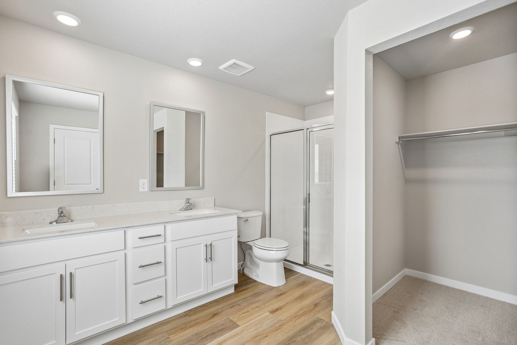 The master bathroom has a large vanity with a step in shower.