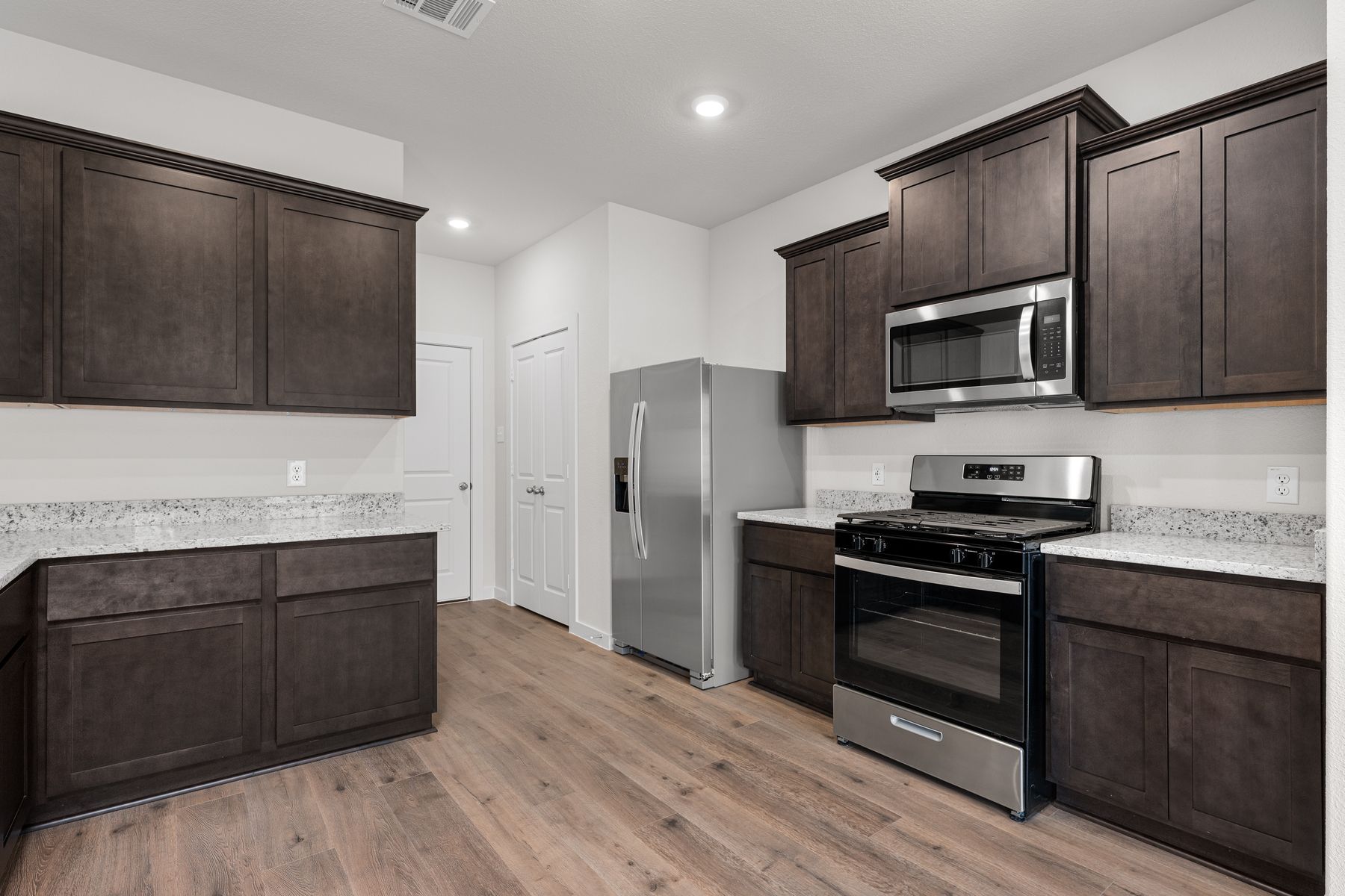 The kitchen has beautiful wood cabinetry.
