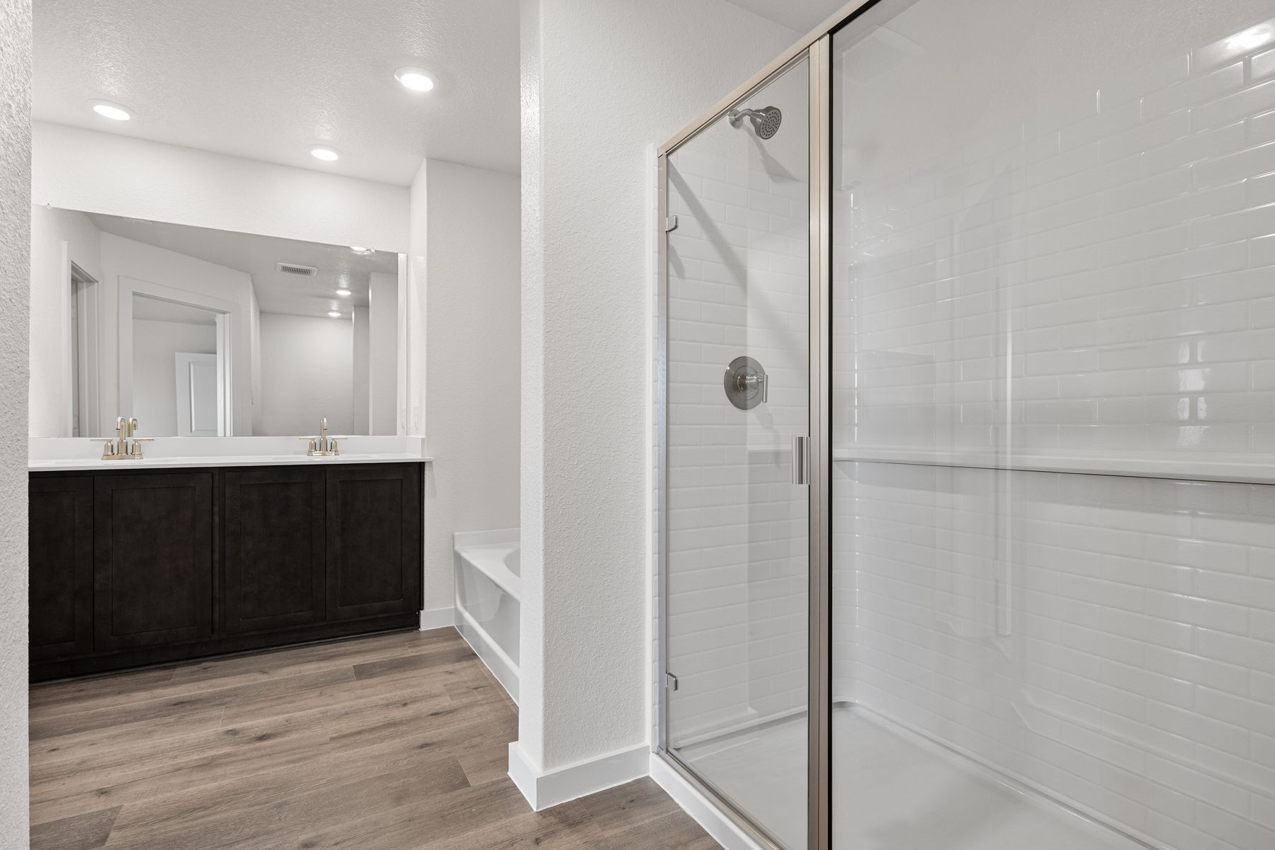 The master bathroom has a glass walk-in shower.
