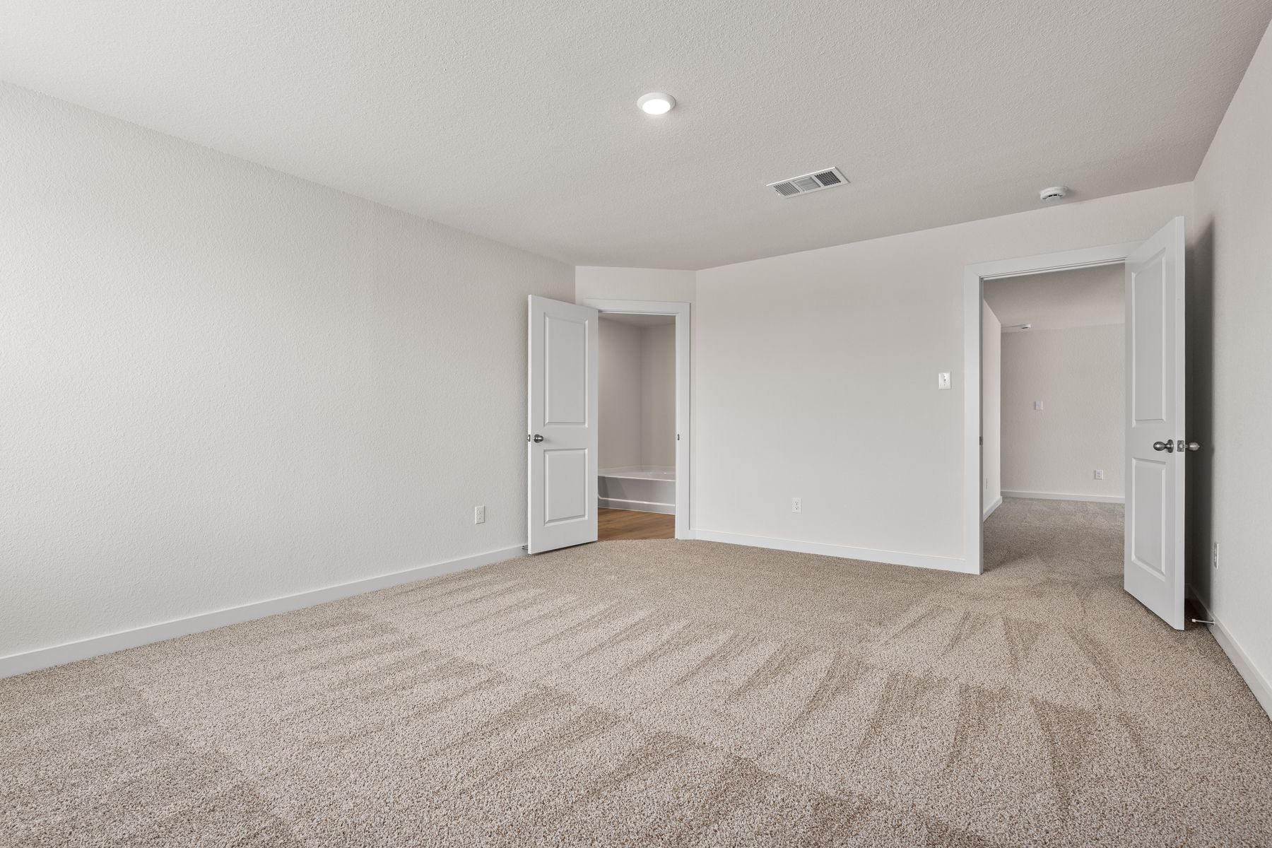 The master suite has a large bedroom, ensuite bathroom and walk-in closet.