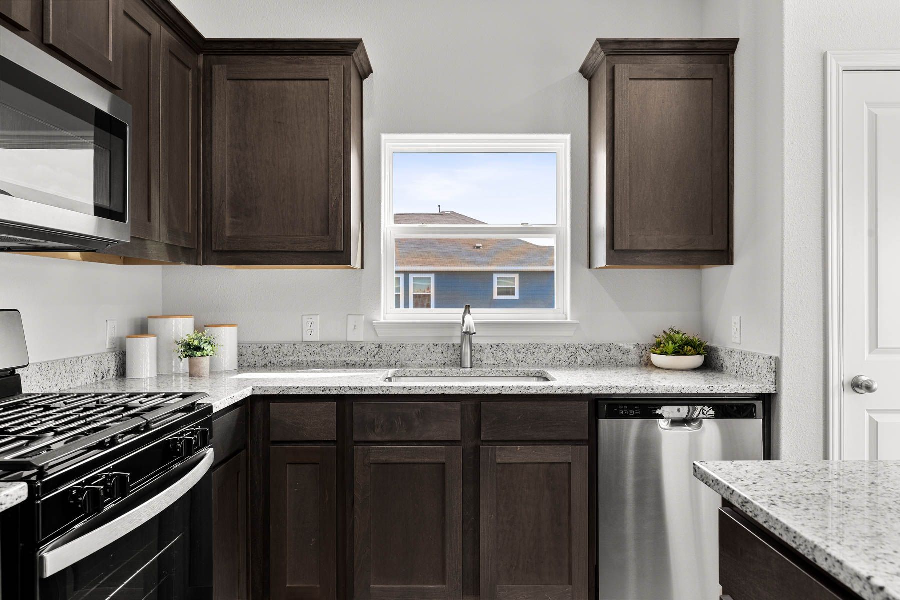 The kitchen has beautiful wood cabinetry. 