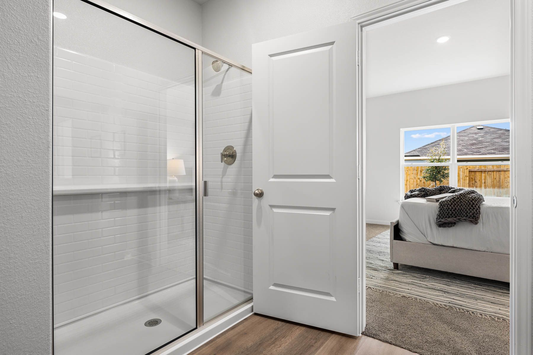The master bathroom has a glass, walk-in shower.