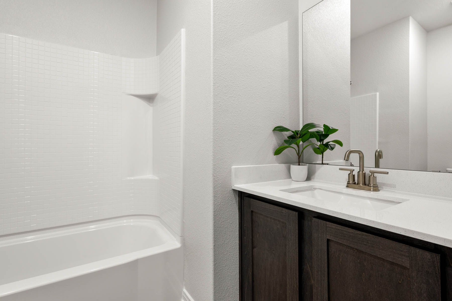 The secondary bathroom has a sprawling vanity.