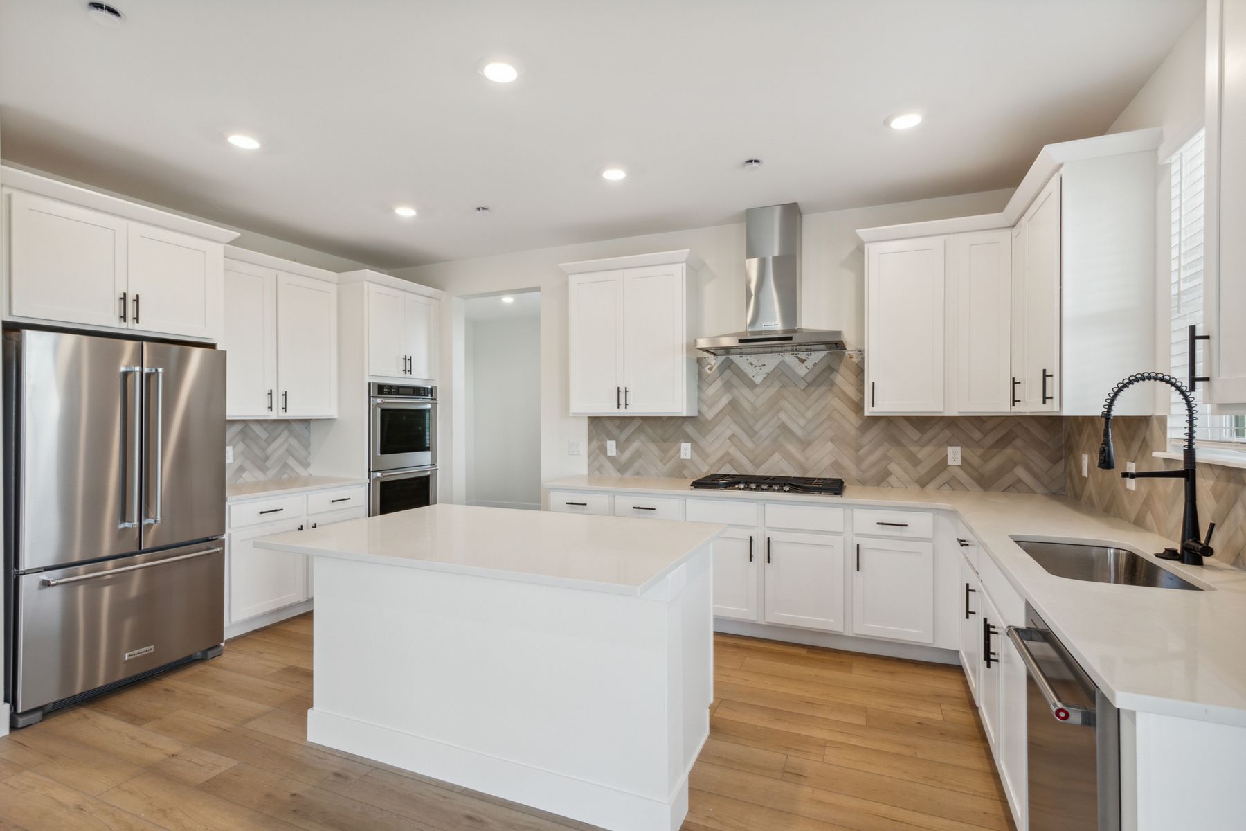 The kitchen has beautiful white wood cabinetry.