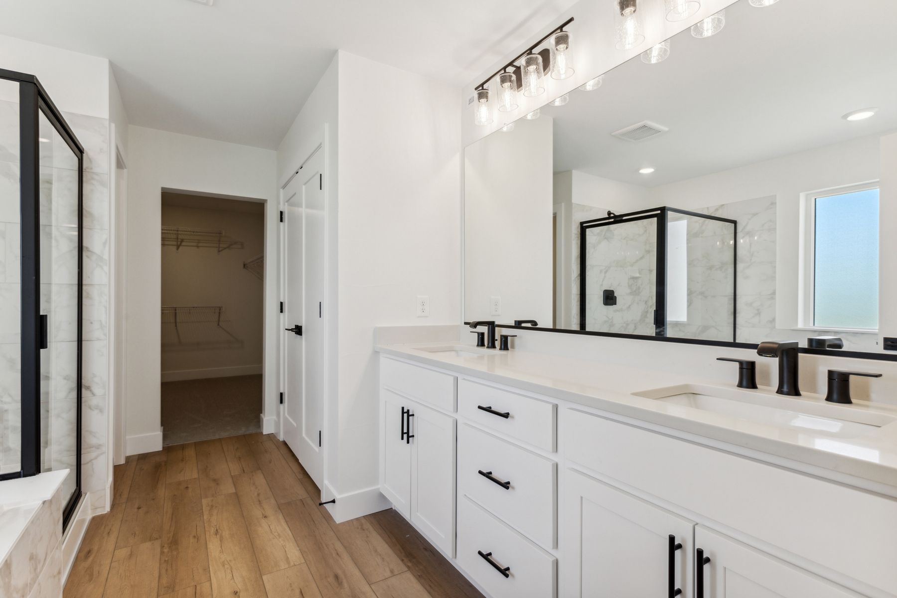 The master bathroom has a sprawling dual-sink vanity. 