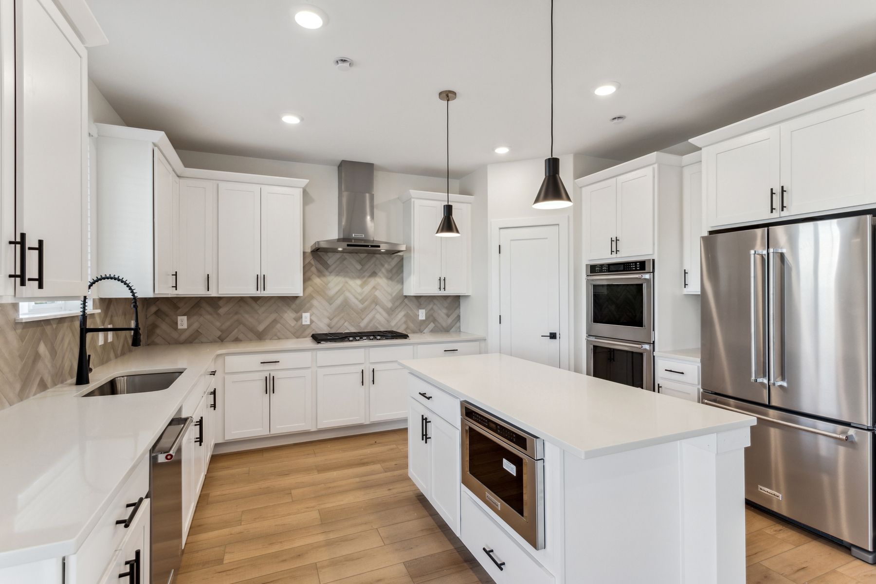 The kitchen has KitchenAid appliances. 