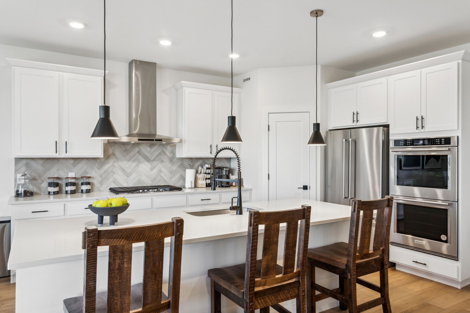 The kitchen has sprawling granite countertops. 