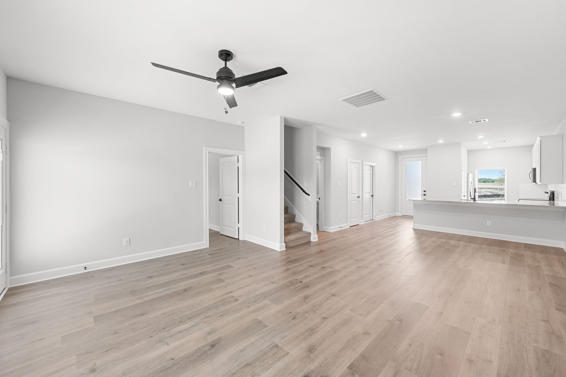 The kitchen, dining room, and living sit next to one another, creating an open-concept layout.