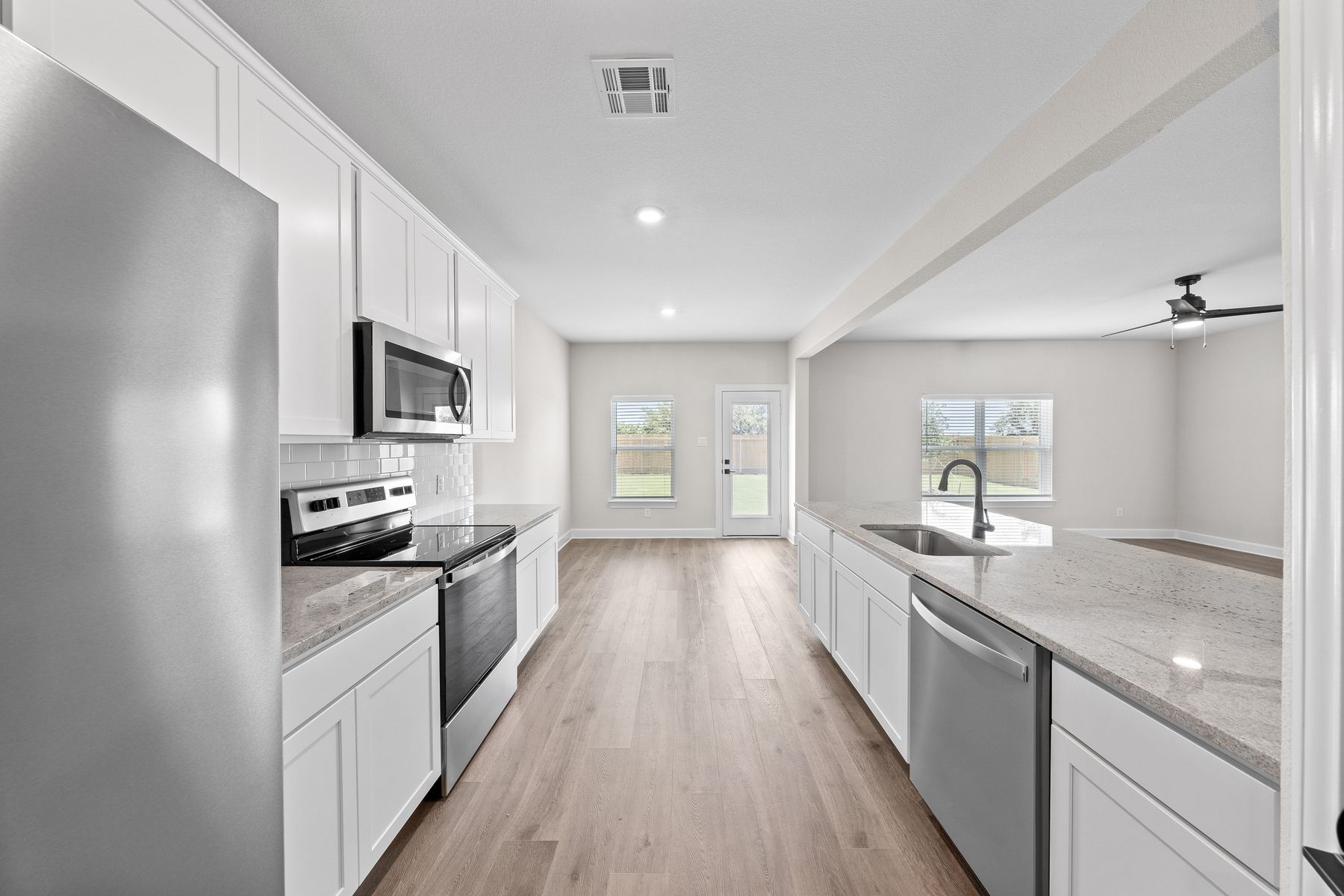 The kitchen has sprawling granite countertops.