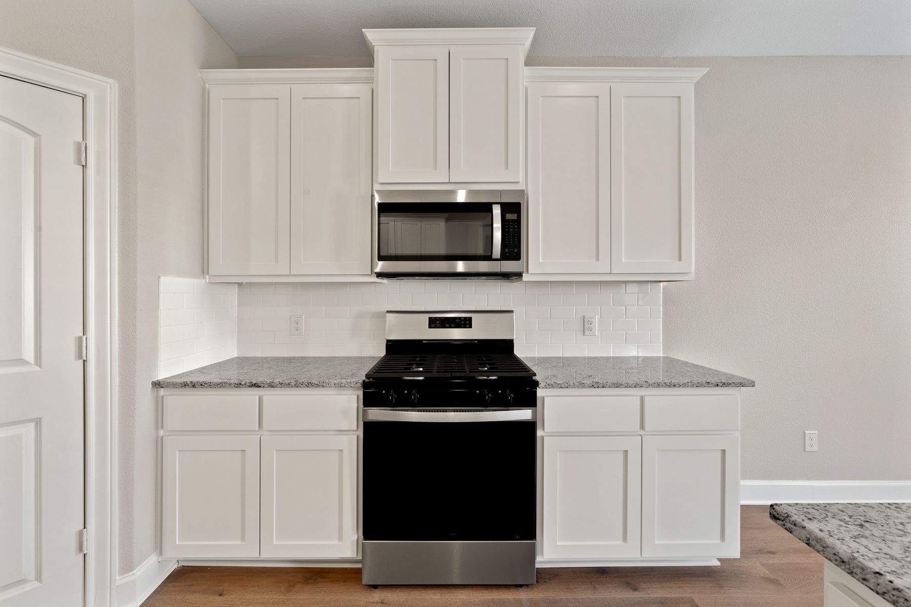 The kitchen has beautiful white cabinets. 