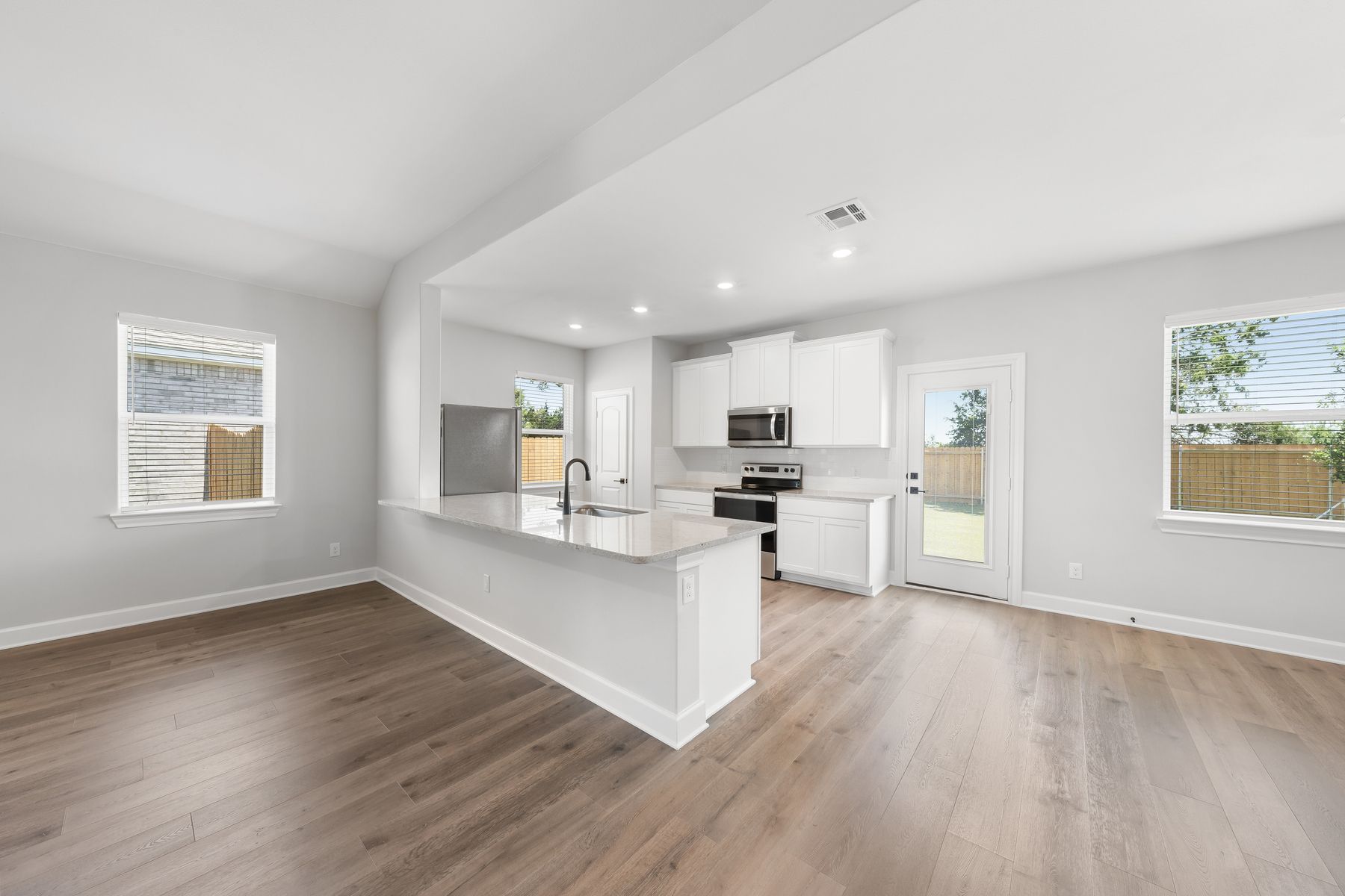 The kitchen, dining room, and living room sit next to each other, creating an open-concept layout.