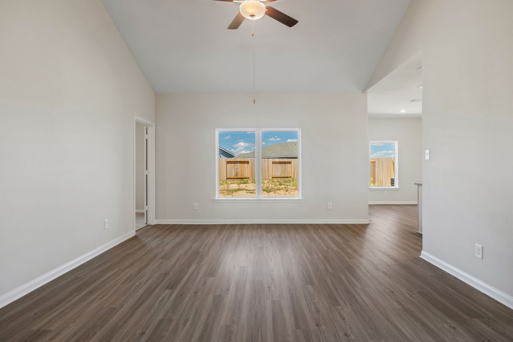 The living room is spacious and has a large window. 