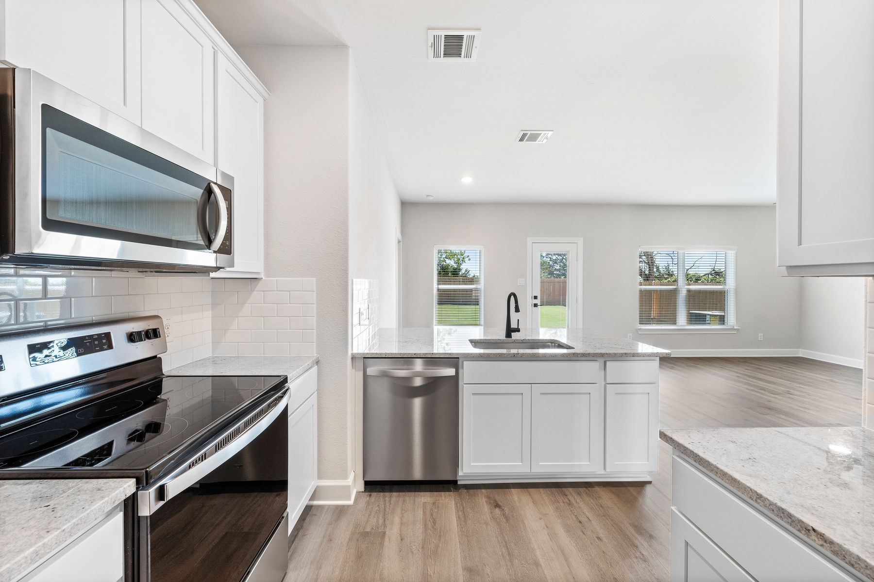 The kitchen looks out into the dining room.