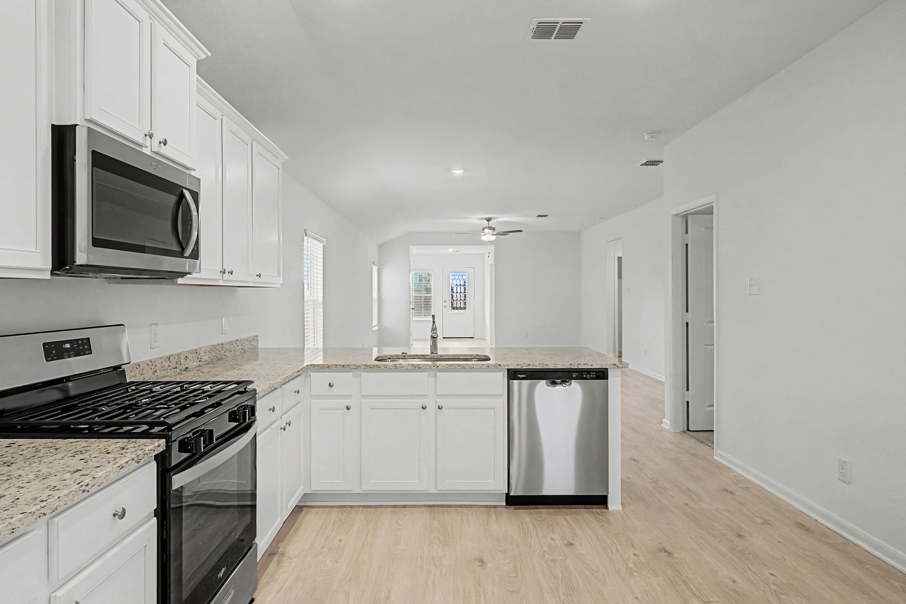 The kitchen looks out into the dining room and family room. 