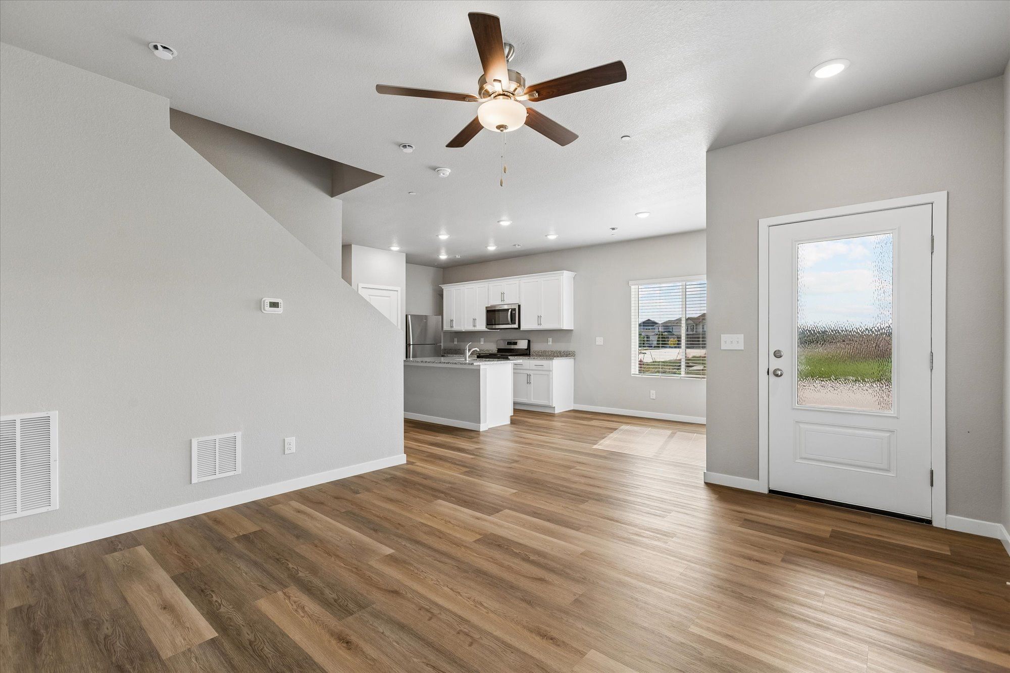 The family room is spacious with a ceiling fan and great natural light.