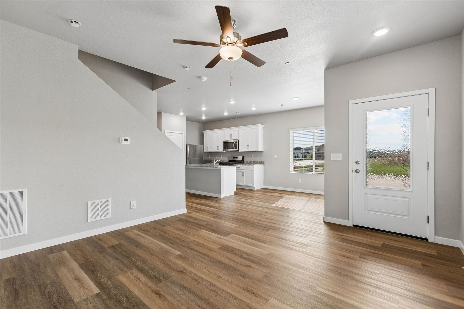 The family room is spacious with a ceiling fan and great natural light.