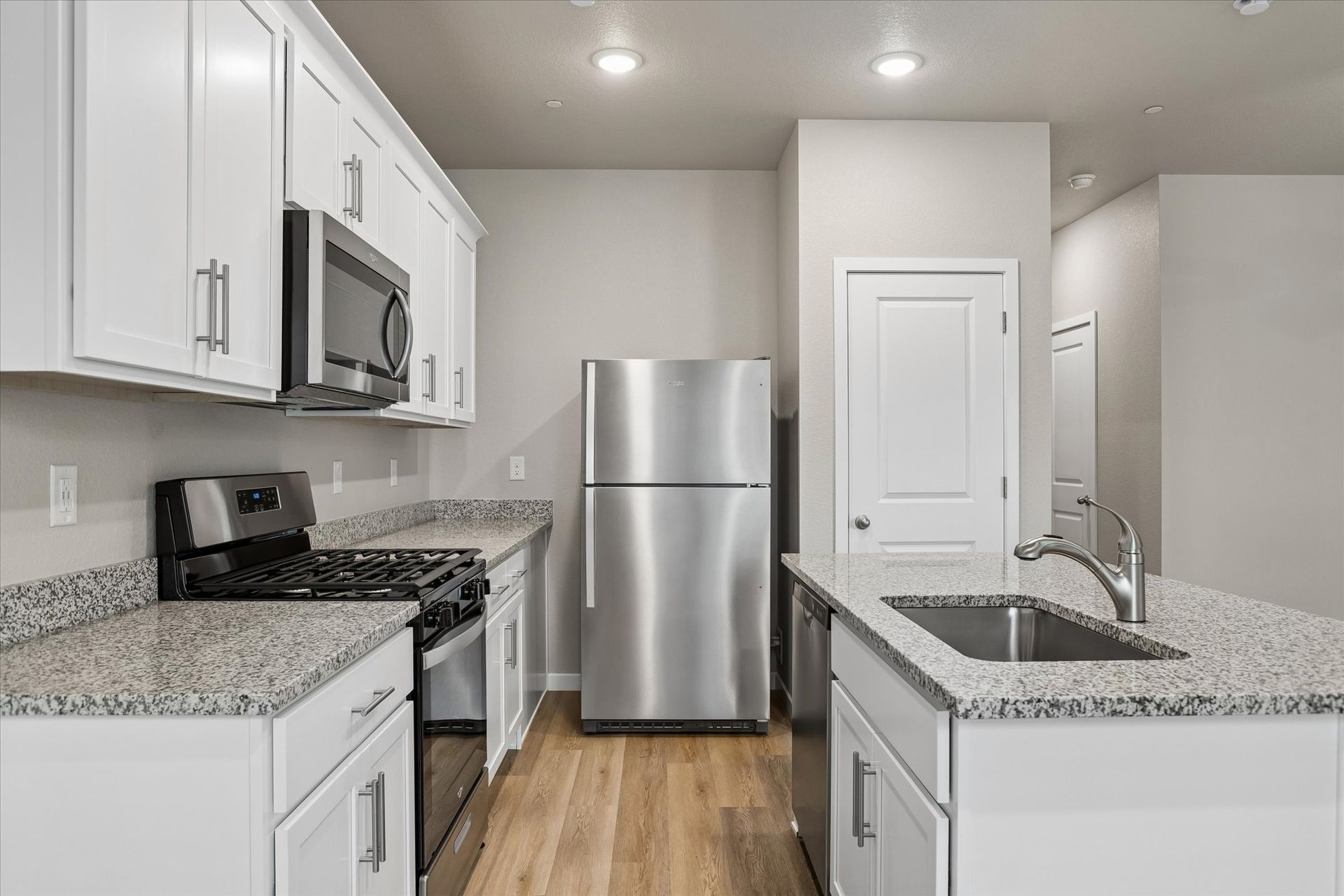 The kitchen has stainless steel appliances and ample room to food prep!