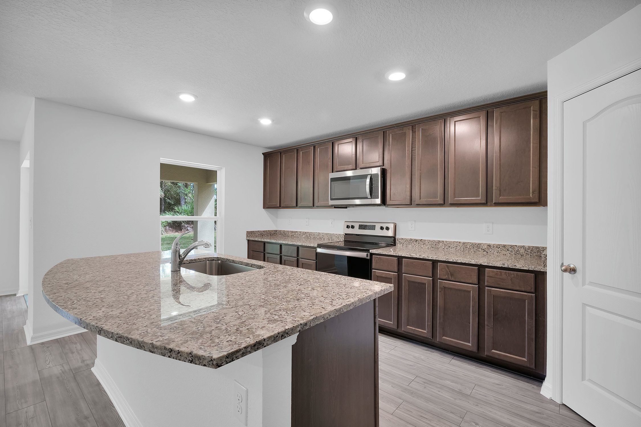 Gorgeous upper-wood cabinets with crown molding provide plenty of storage space