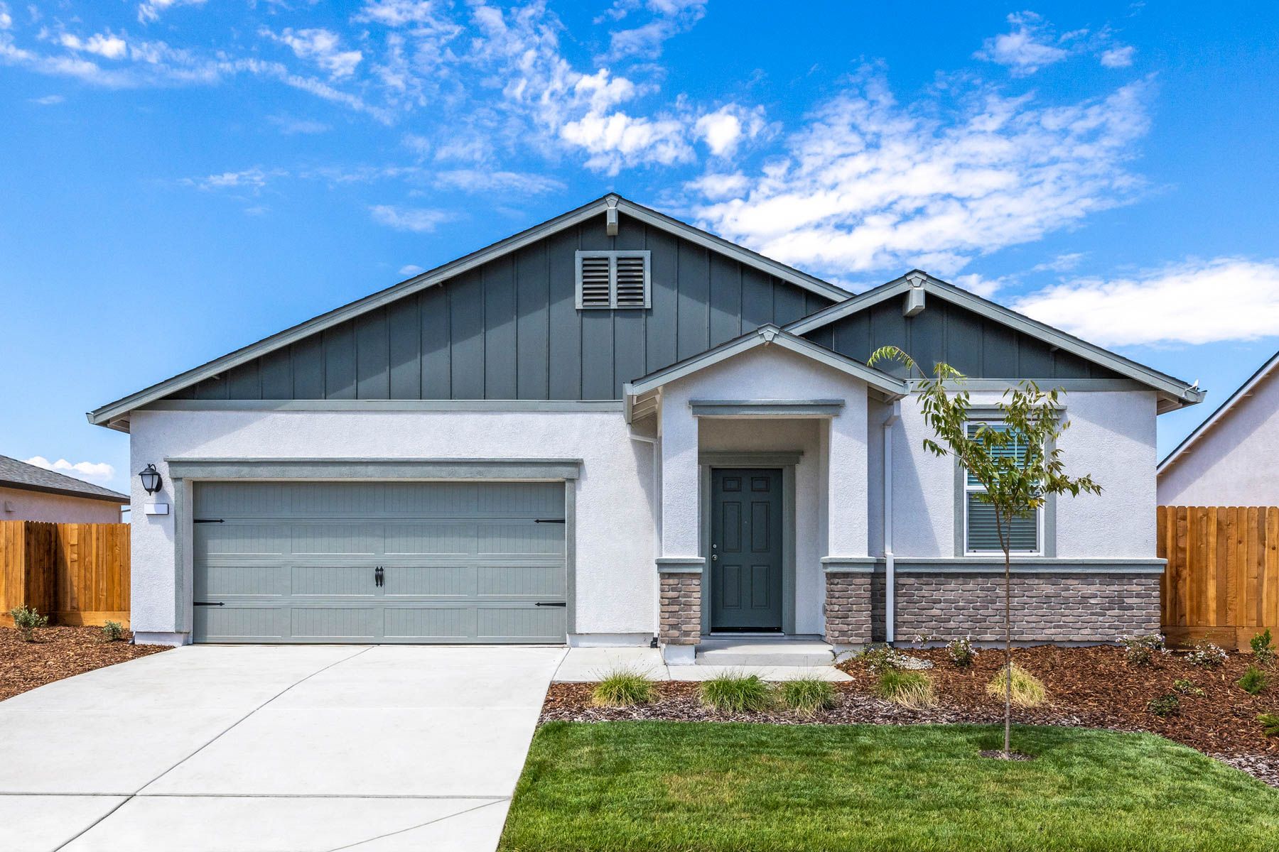The Carmel is a single-story home with stucco and stone.