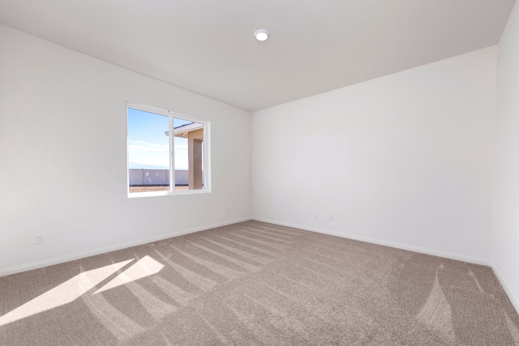 The master bedroom has enough space for a queen sized bed and two side tables