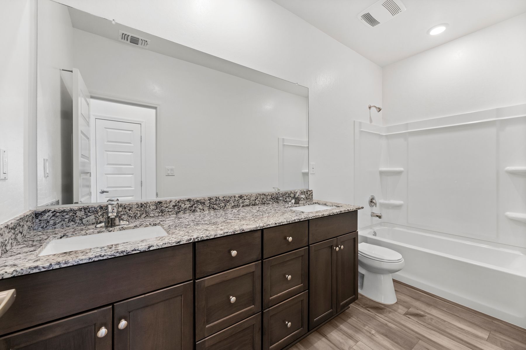 The secondary bathroom has a tub/shower combo and a large vanity.
