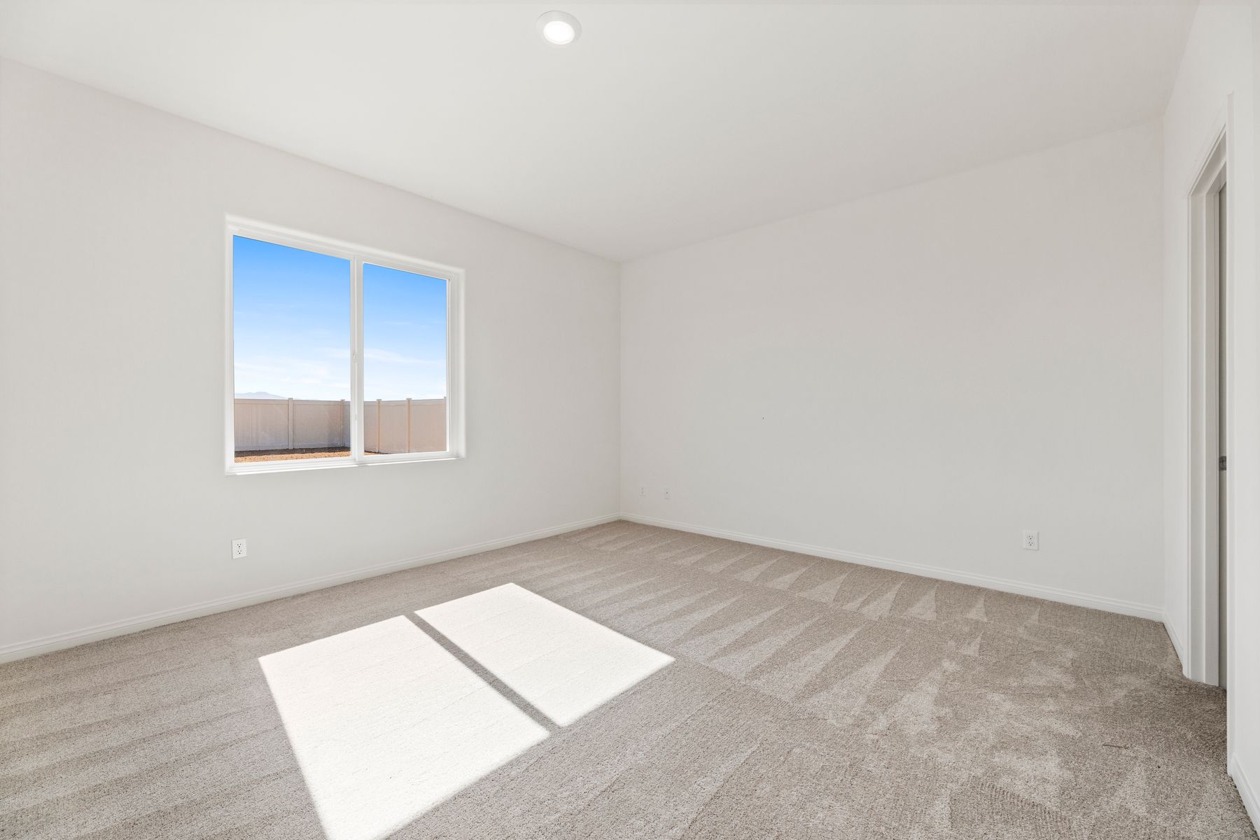 The master bedroom has enough space for a queen sized bed and two side tables