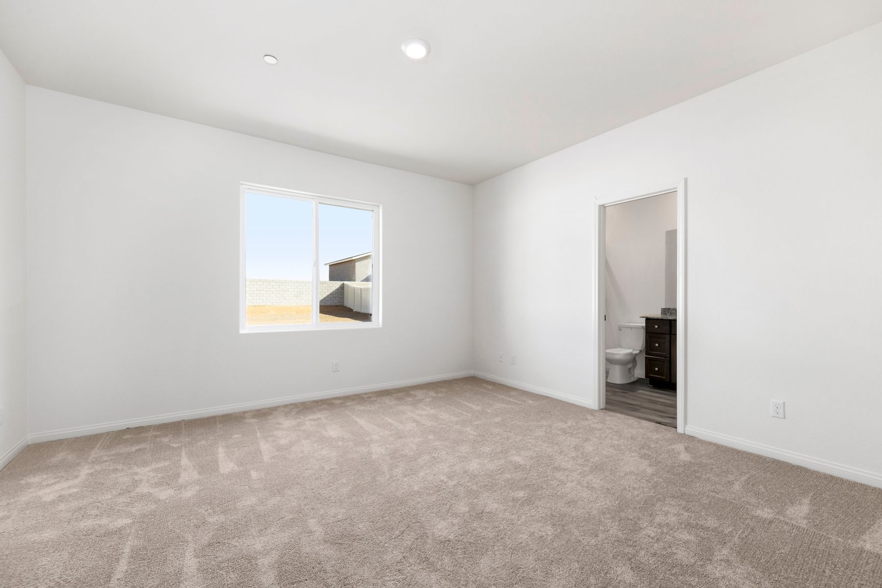 The master bedroom has enough space for a queen sized bed and two side tables