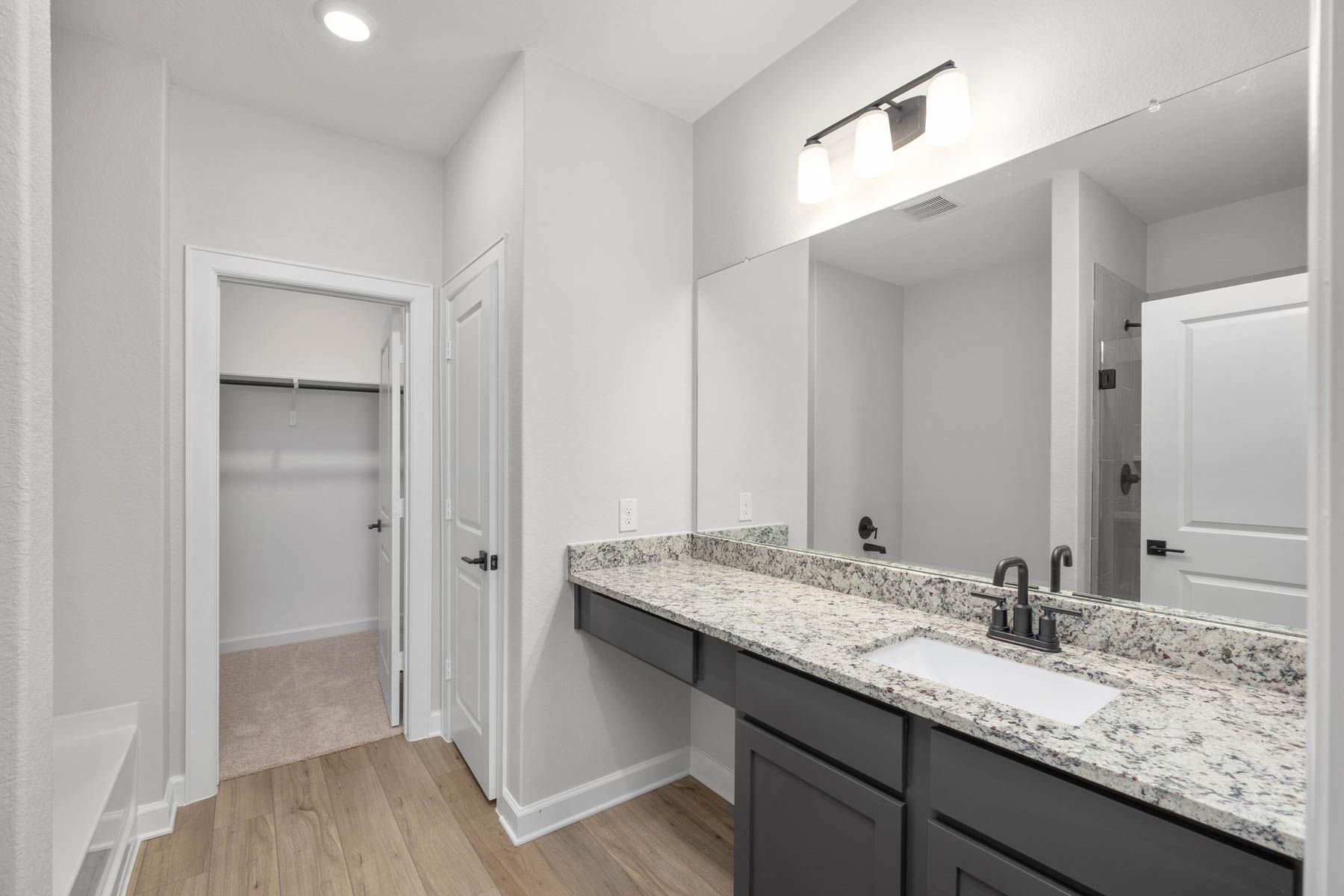 The master bathroom has a large vanity and step in shower!
