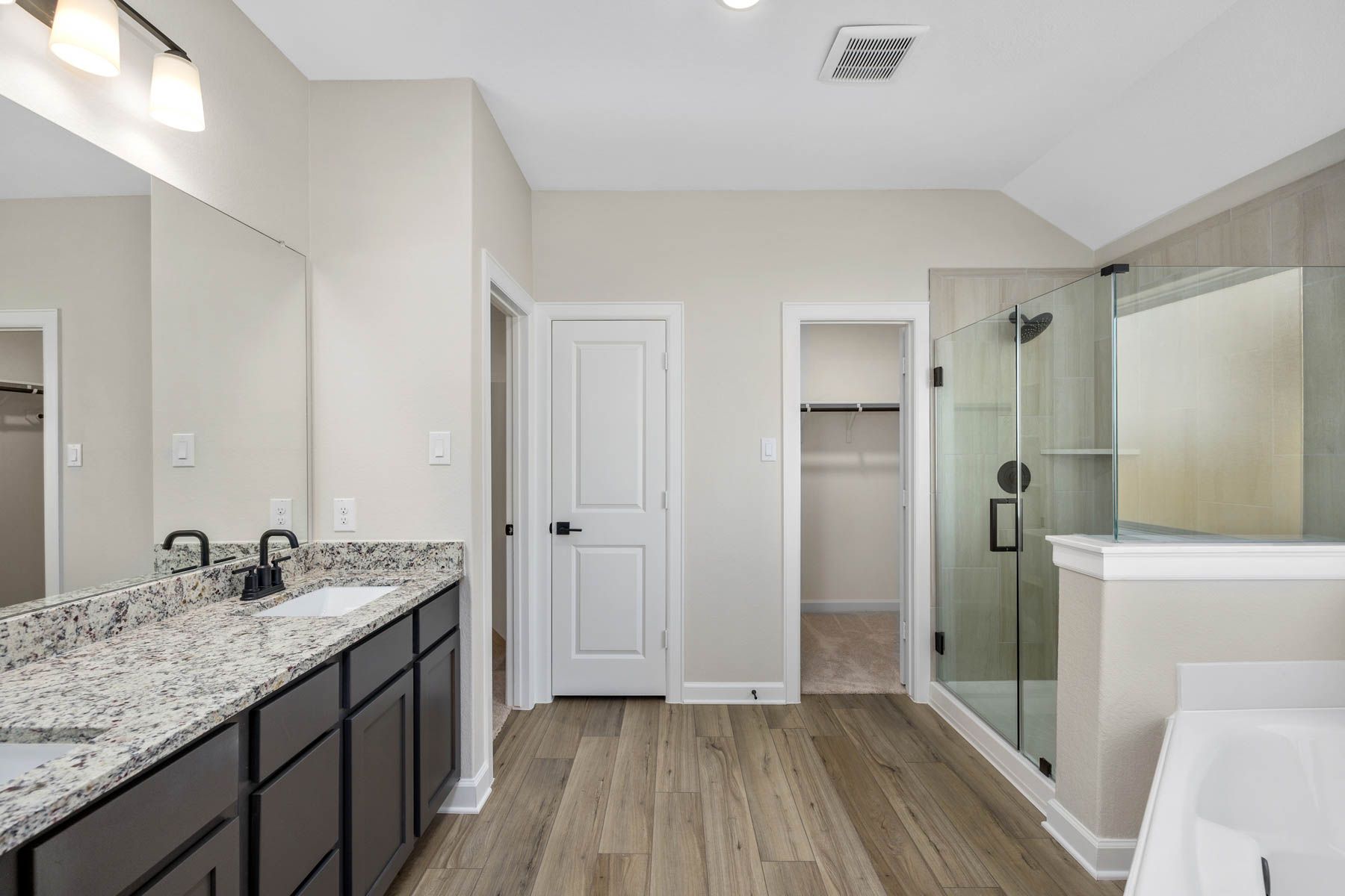 The master bathroom has a large vanity and step in shower!