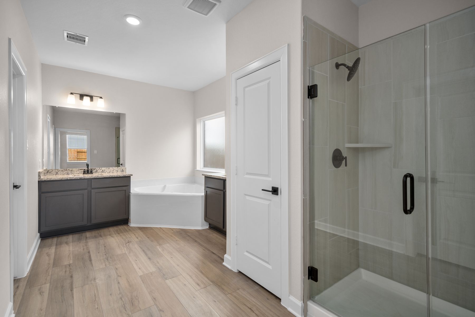 The master bathroom has a large dual sink vanity and step in shower!
