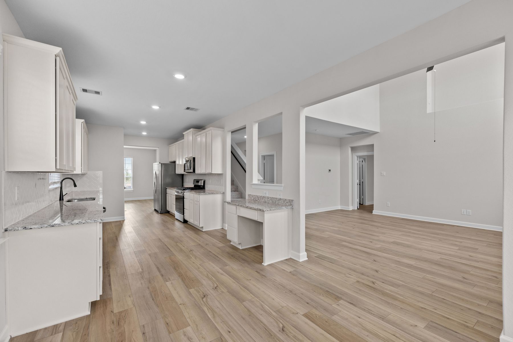 The open concept Redwood plan has the kitchen open to a dining area and the spacious family room.