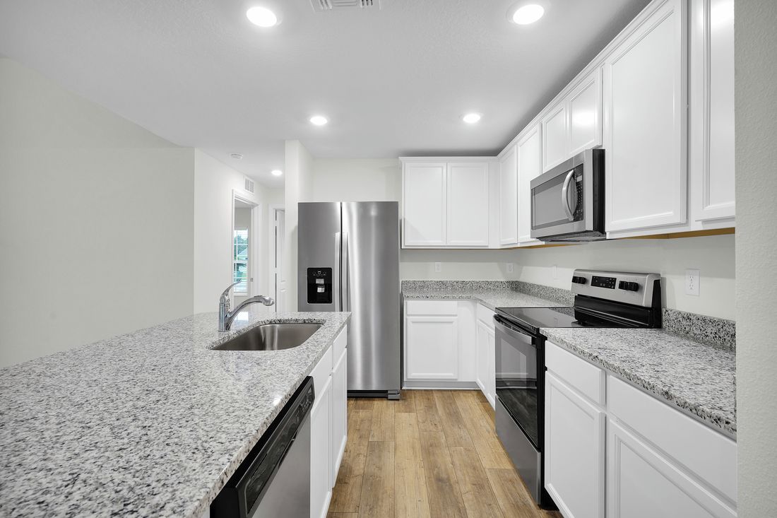 The kitchen is chef-ready with stainless steel appliances