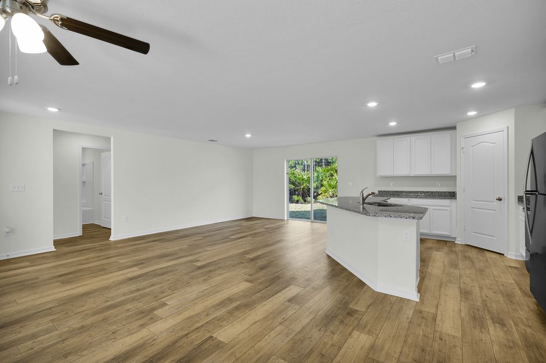The entertainment space of the Caladesi is open-concept and includes the dining room, living room, and kitchen