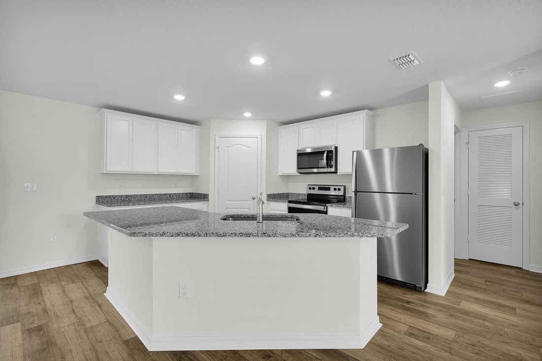The kitchen has a large island that will be perfect for you and your family to gather around